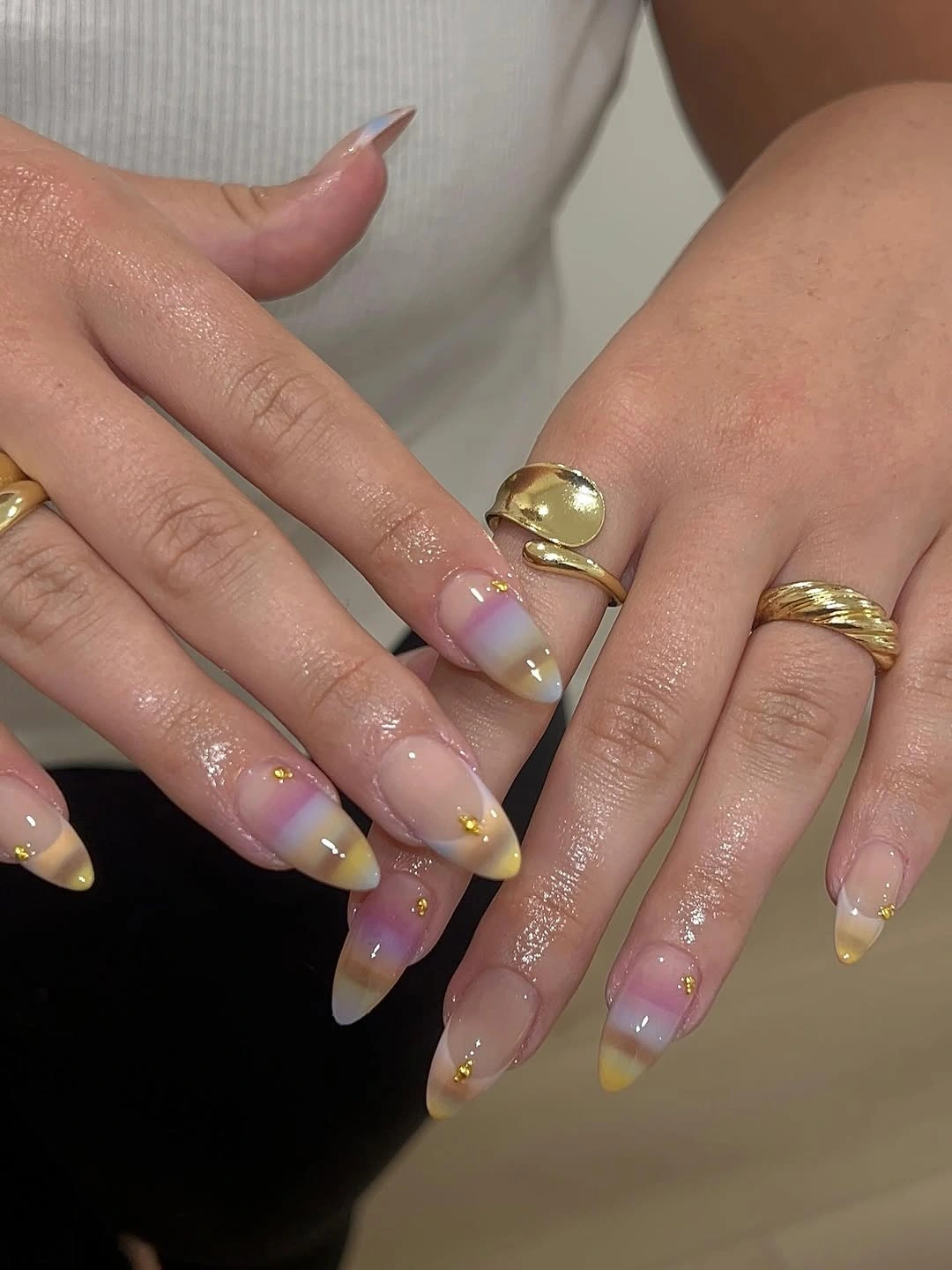 Long stiletto nails with translucent tips and tiny colorful accents