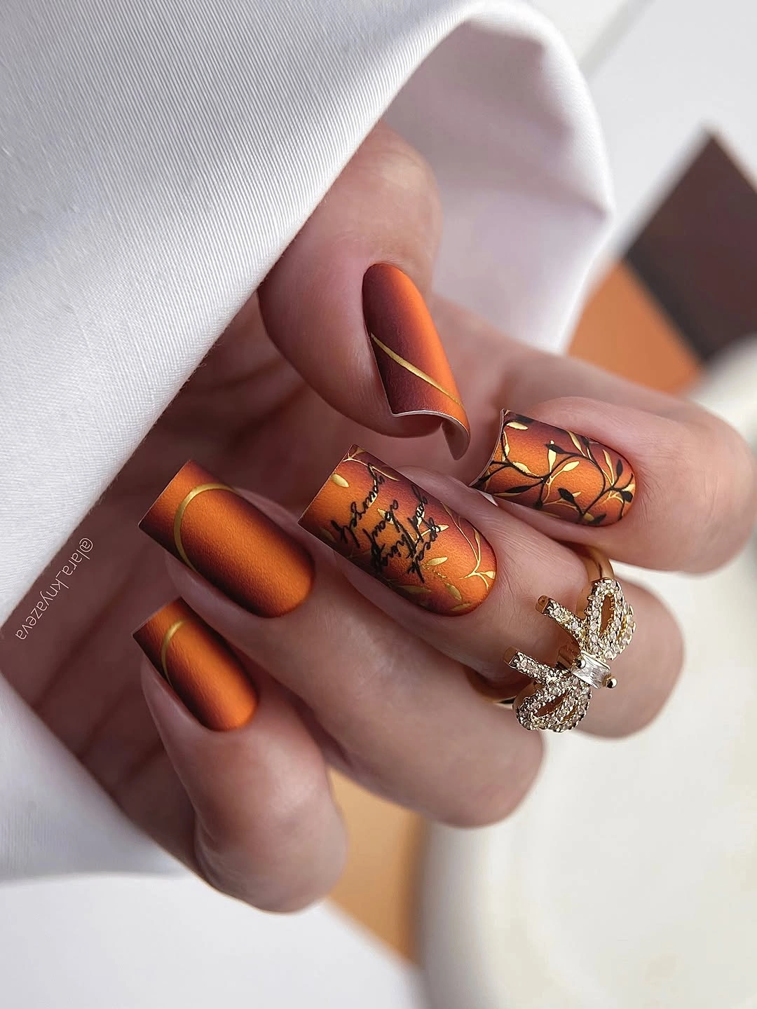 Medium almond burnt orange nails with brown and gold autumn details