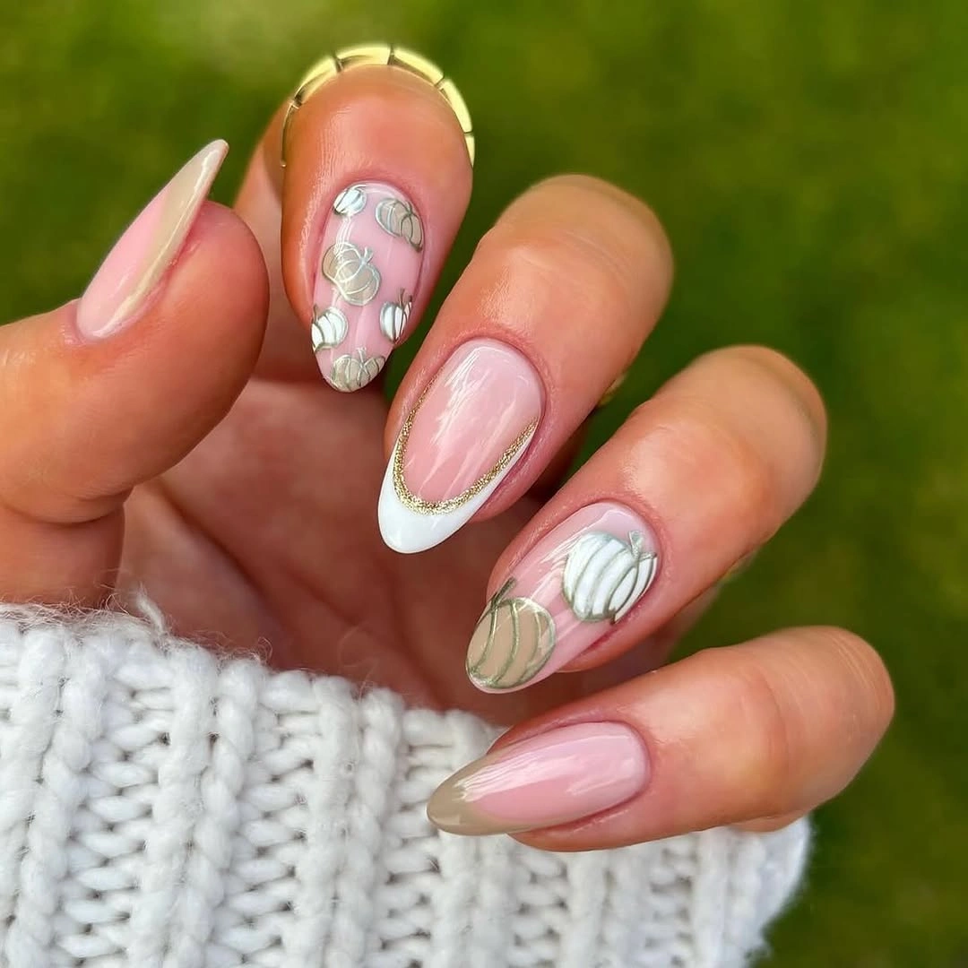 Soft pumpkin almond nails with gold trim