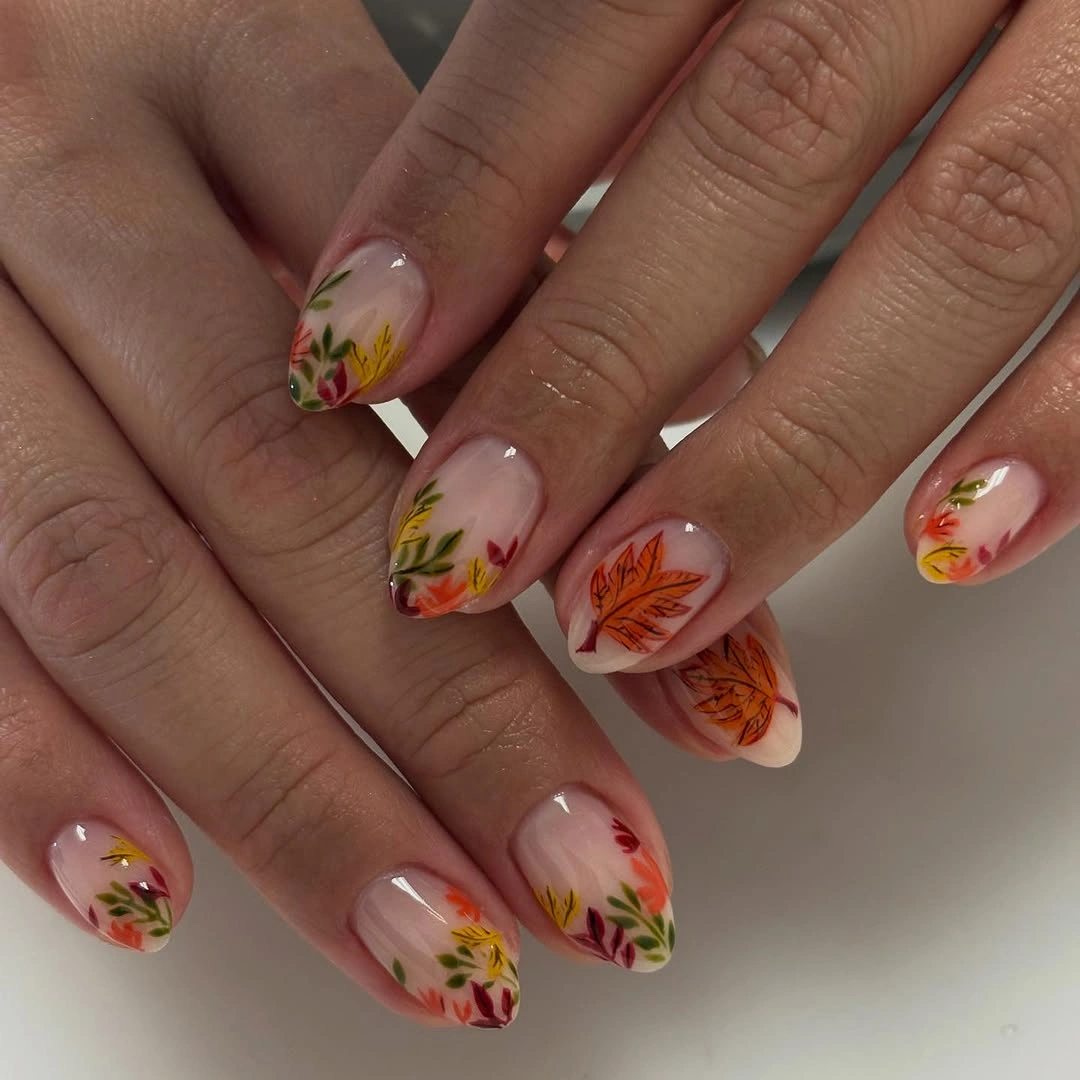 Milky almond nails with tiny autumn leaves