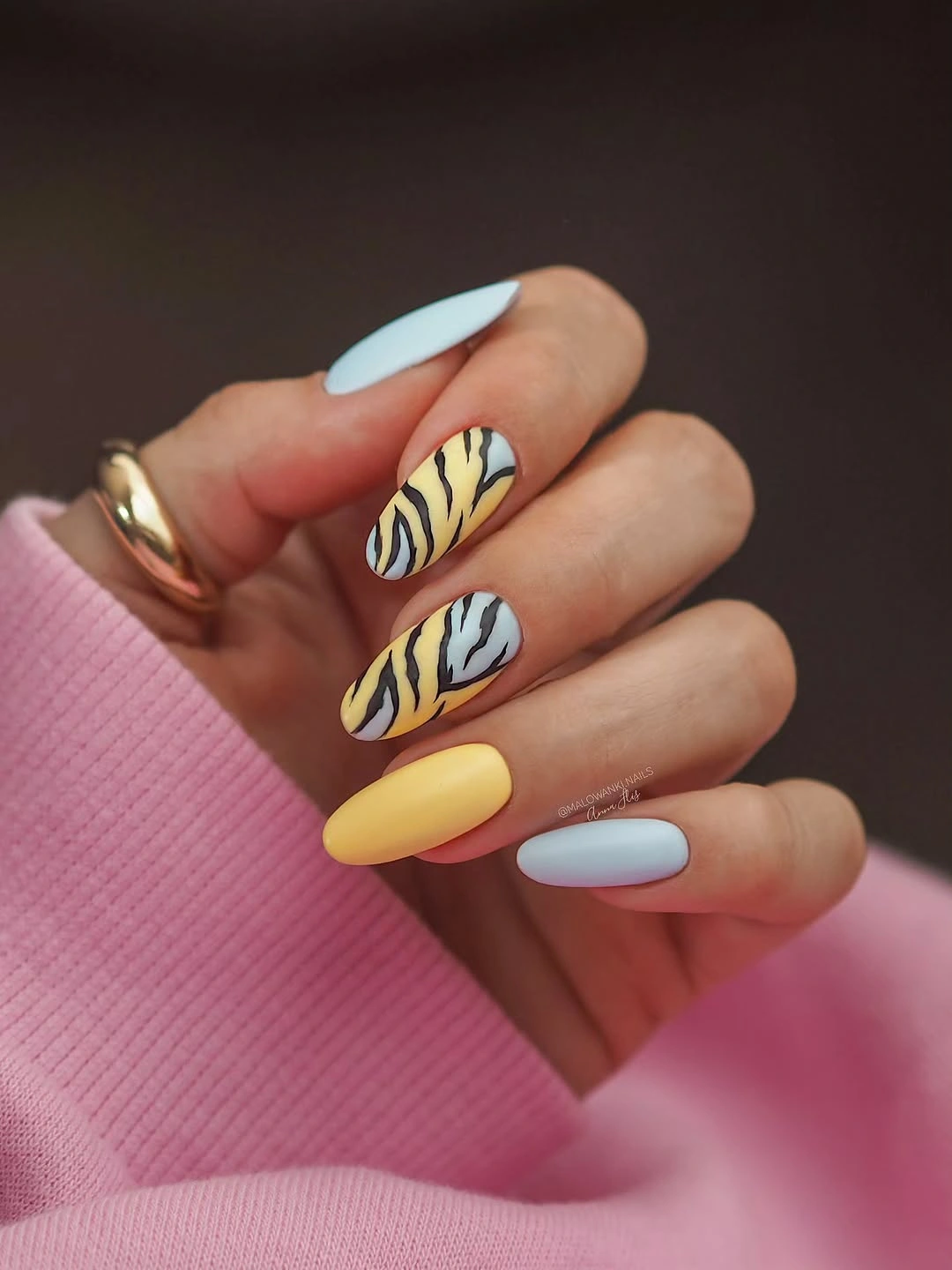 Matte pastel almond nails with black stripes