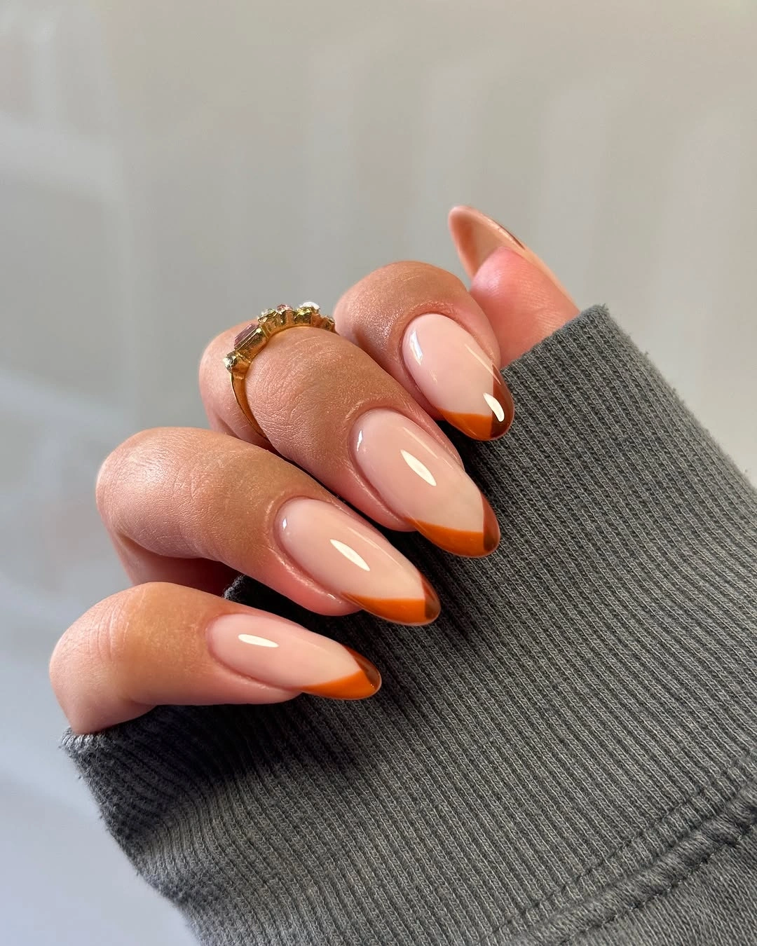 Simple amber French tips on almond nails