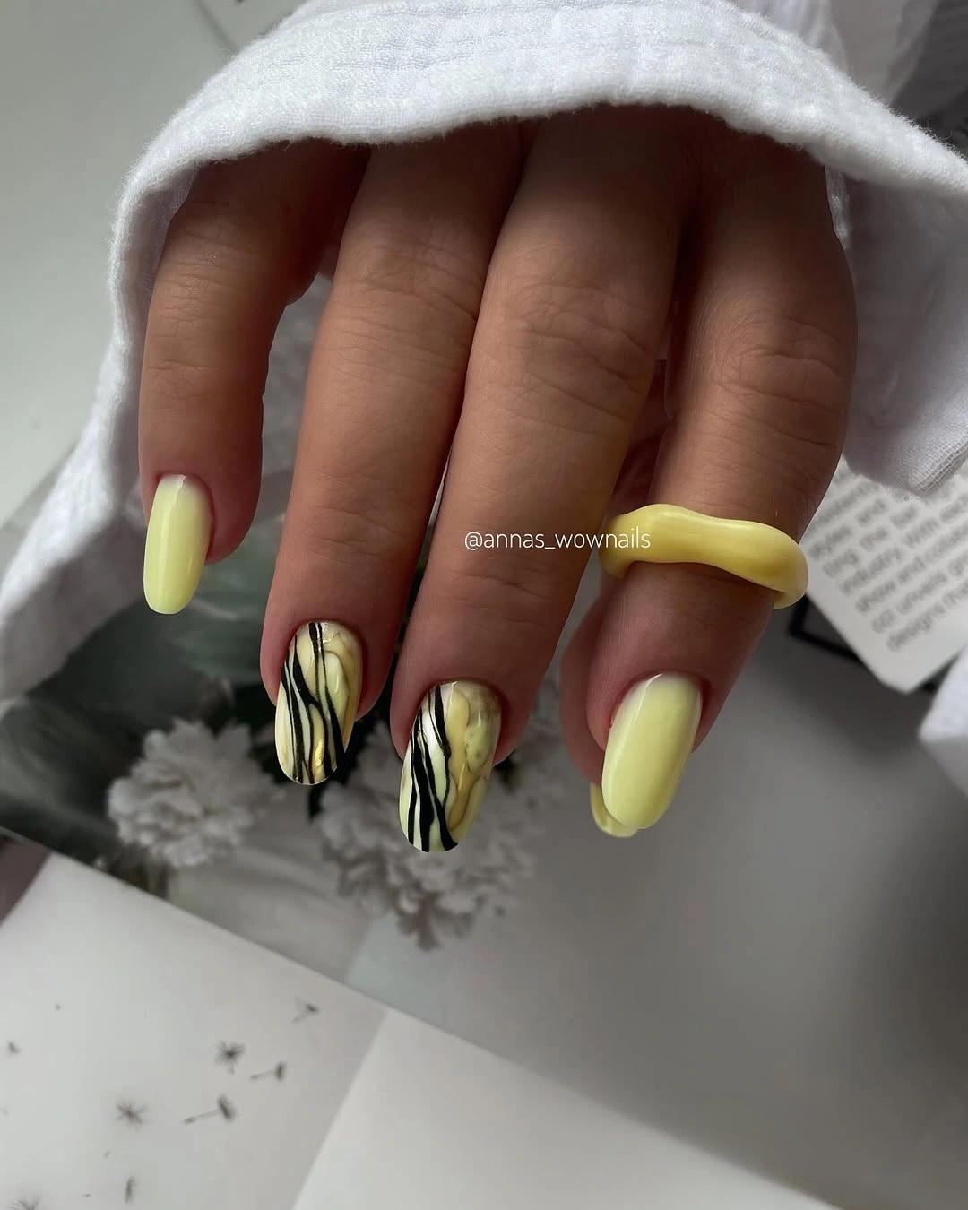 lime yellow almond nails with black leaf marks