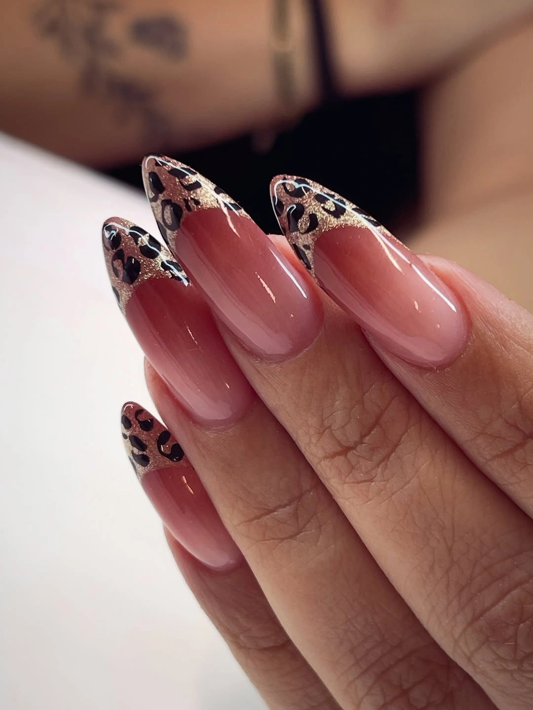 Burgundy almond nails with leopard patterned tips