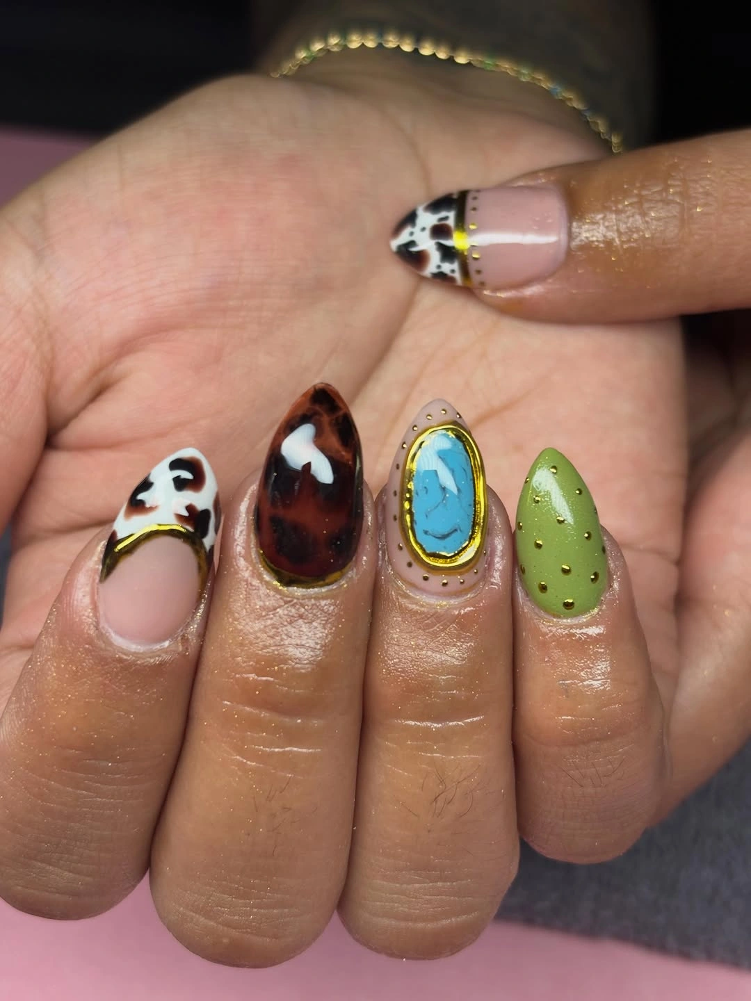 Short mixed nails with cow print and tortoise details
