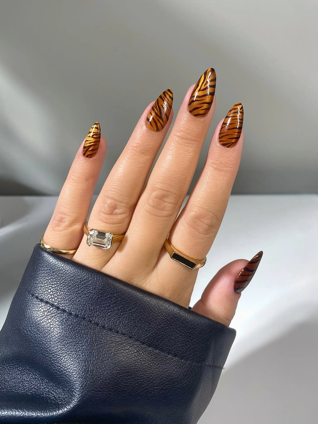 Warm brown almond nails with black tiger stripes
