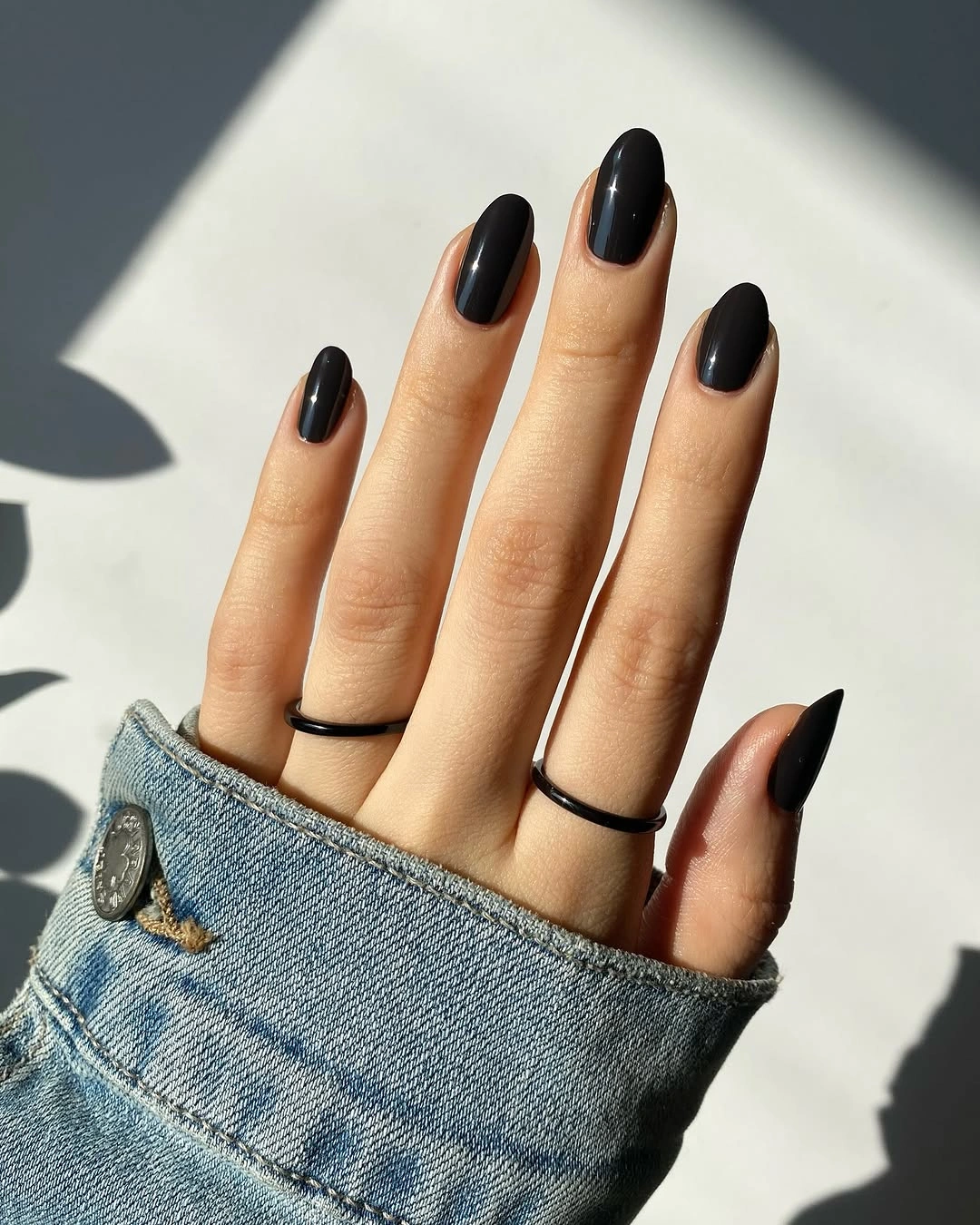 Medium oval nails with a clean glossy black finish