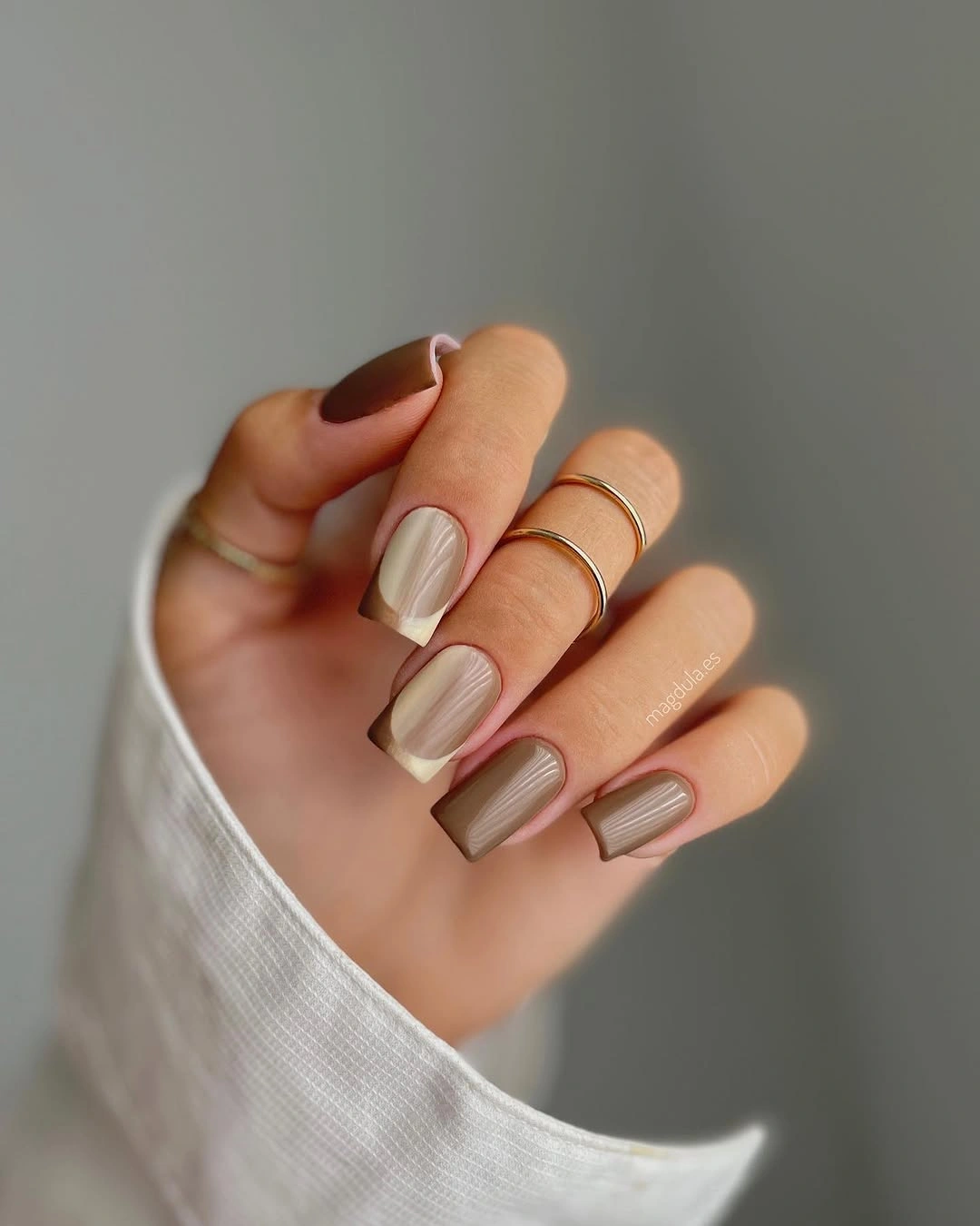 Medium almond nude nails with cream and brown curved tips