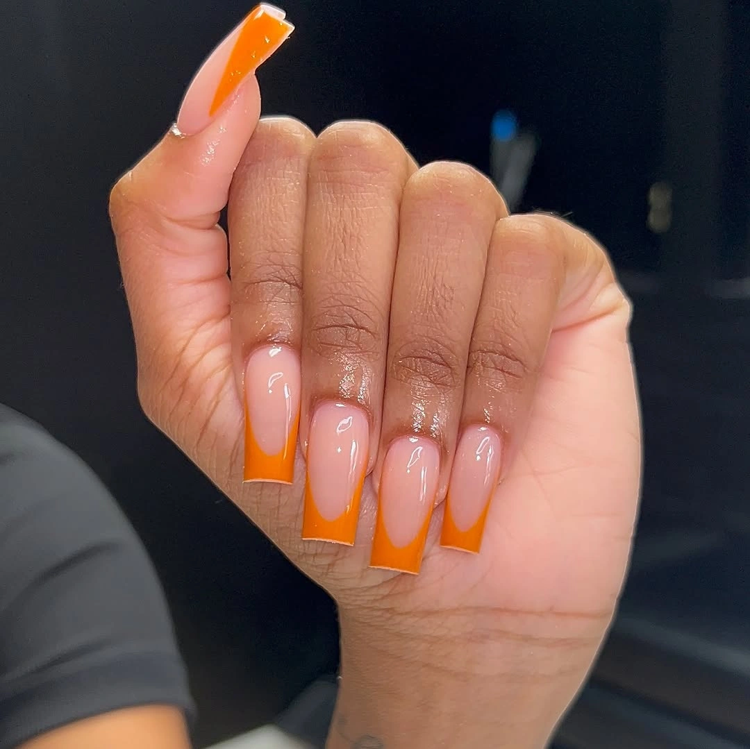 Long square nails with vivid orange office French tips