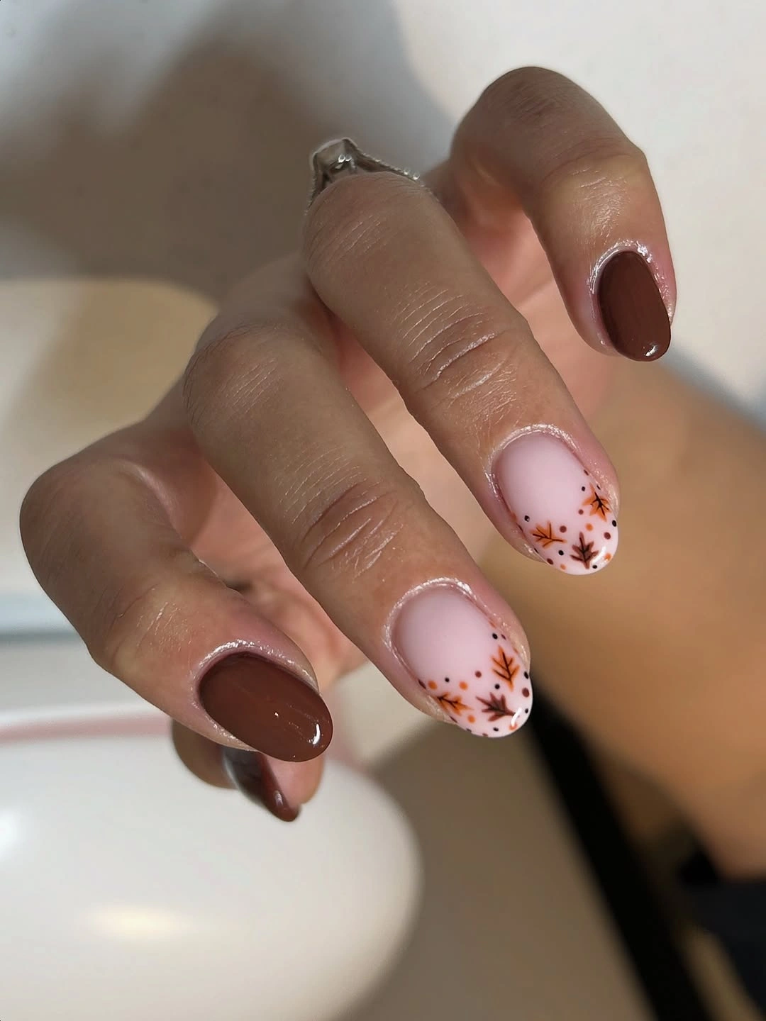 Short almond chocolate nails with blush floral details