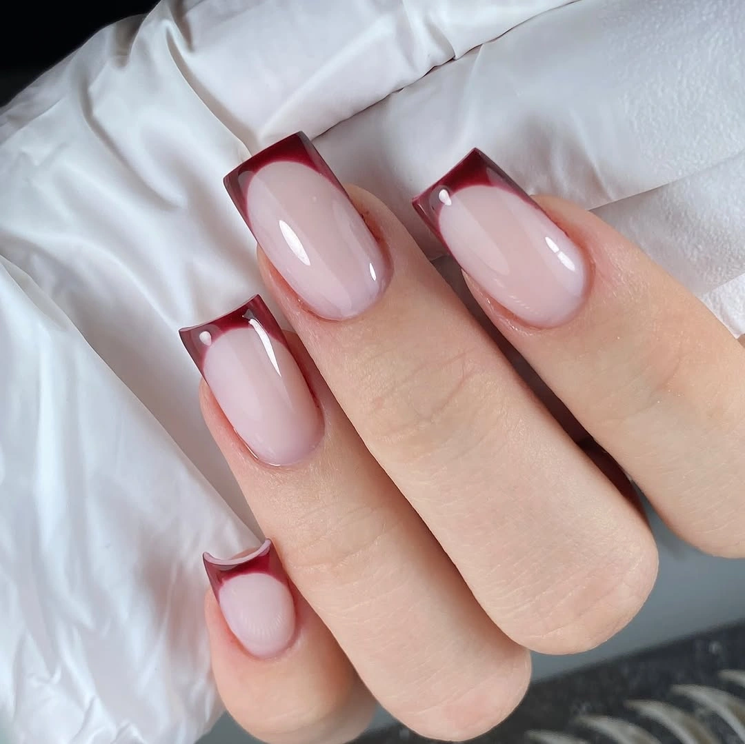 Soft pink square nails with cherry red French lines