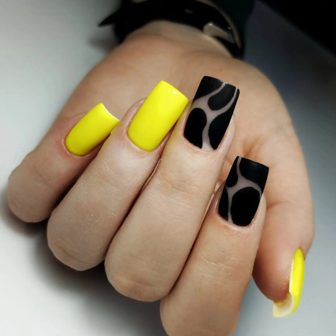 Neon yellow square nails with black abstract marks