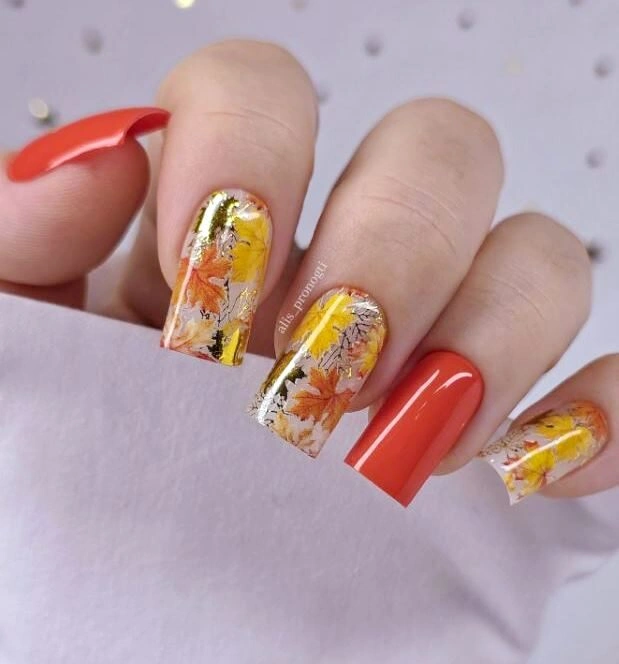 Orange red square nails with translucent floral details