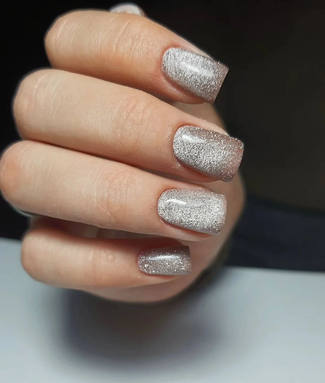 Short square nails with a bright silver chrome finish