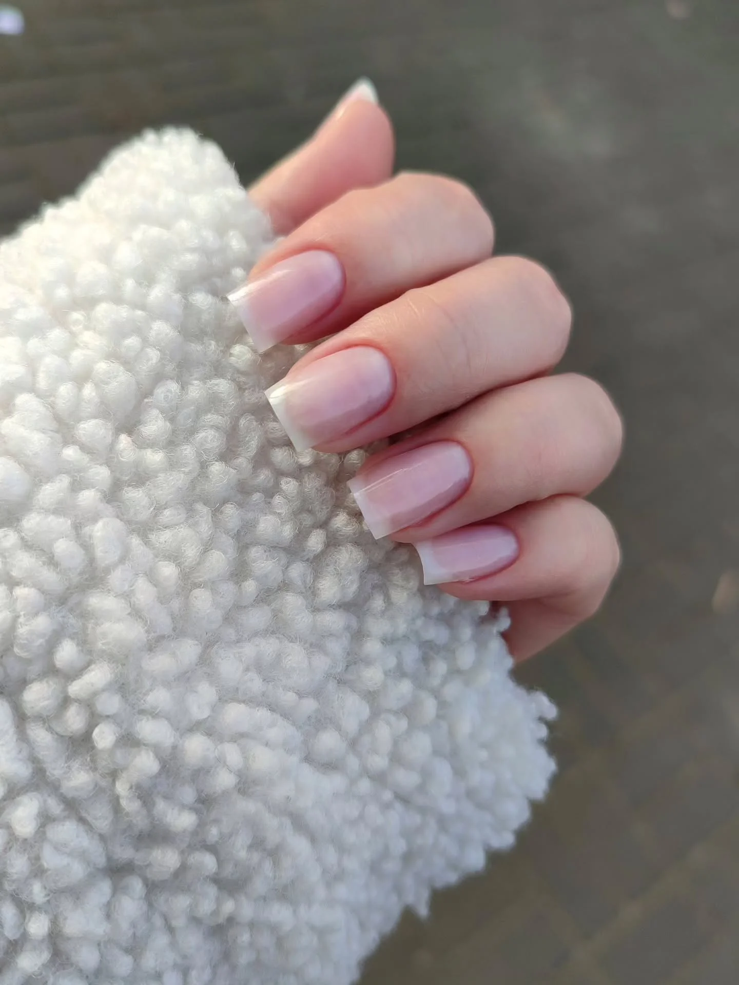 Short square nails in a pale pink glossy shade