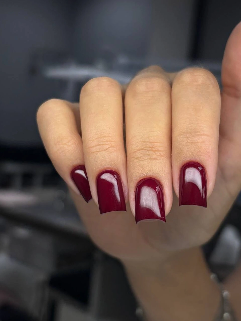 Burgundy square nails with nude negative-space arches