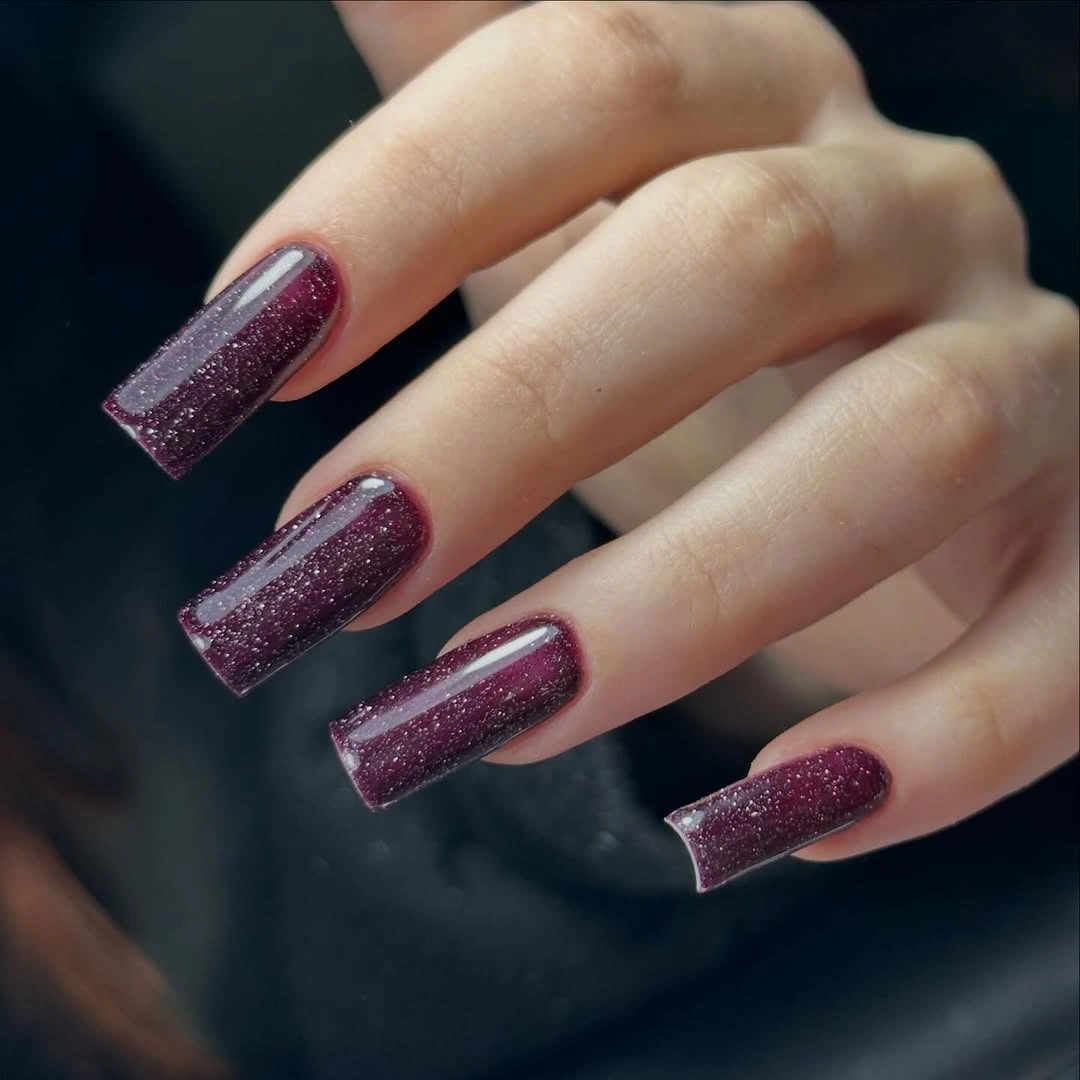 Long square nails with deep plum shimmer