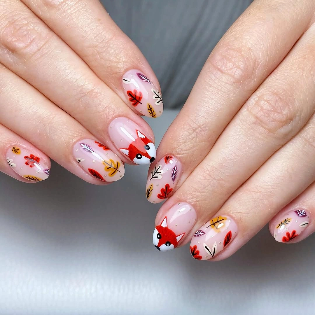 Short square pink nails with flowers and small red orange illustrated accents