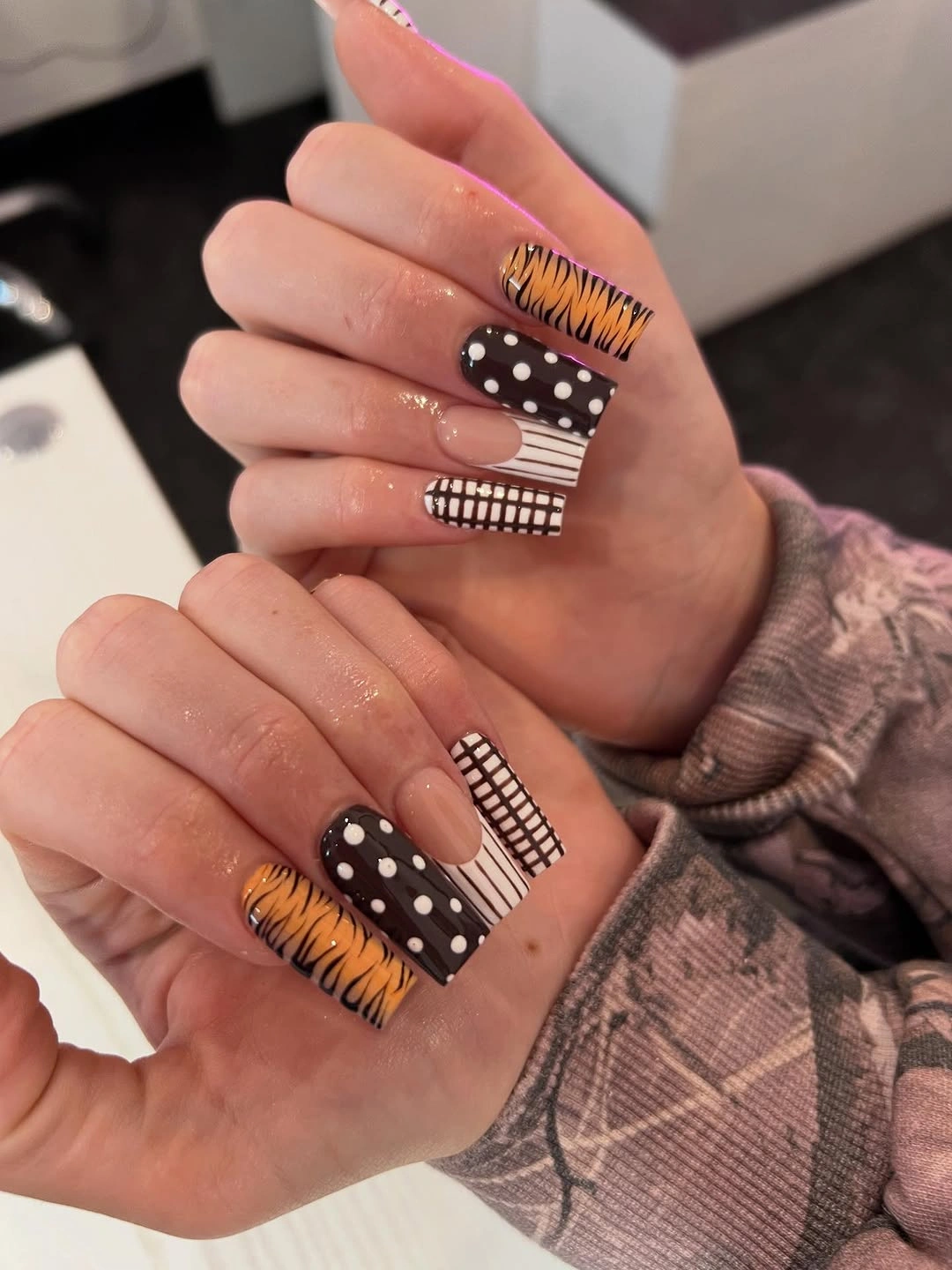 Medium coffin nails with orange black white and brown graphic patterns