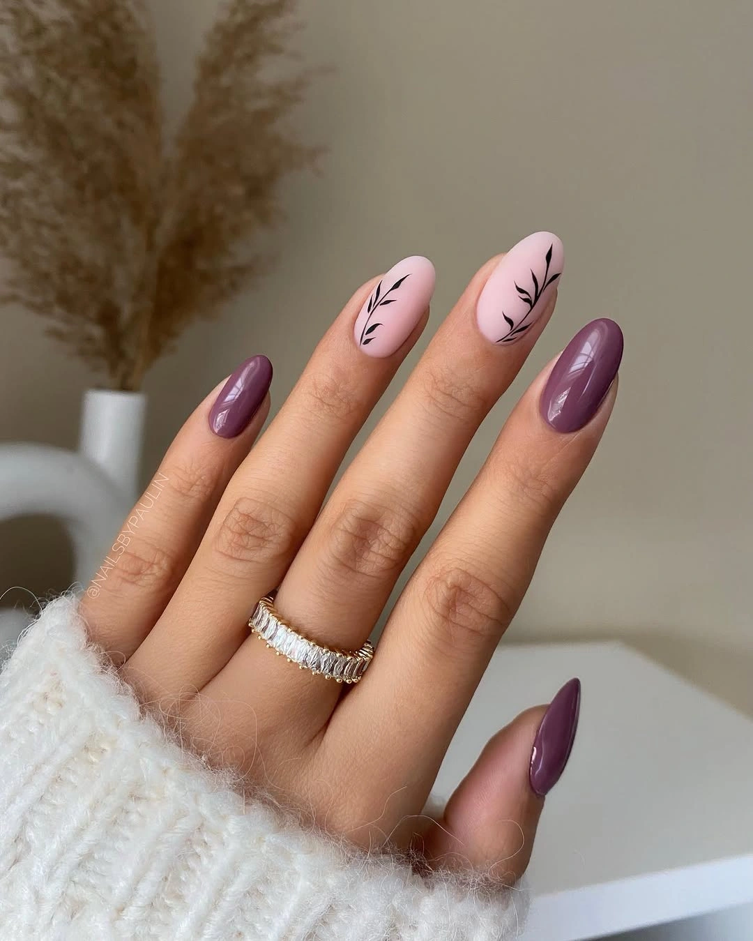 Medium mauve almond nails with delicate black leaf-like marks