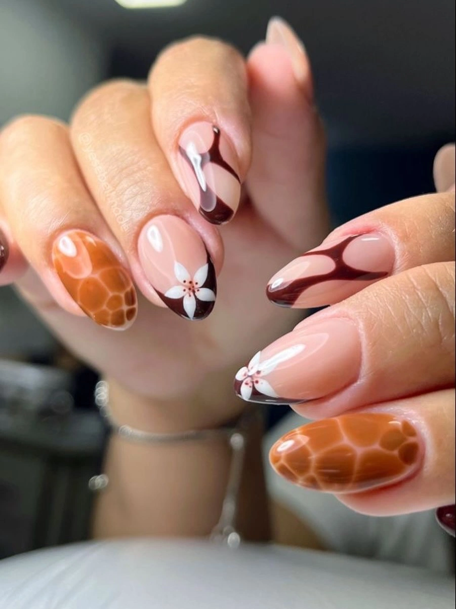 Terracotta tortoiseshell almond nails with black and white accents
