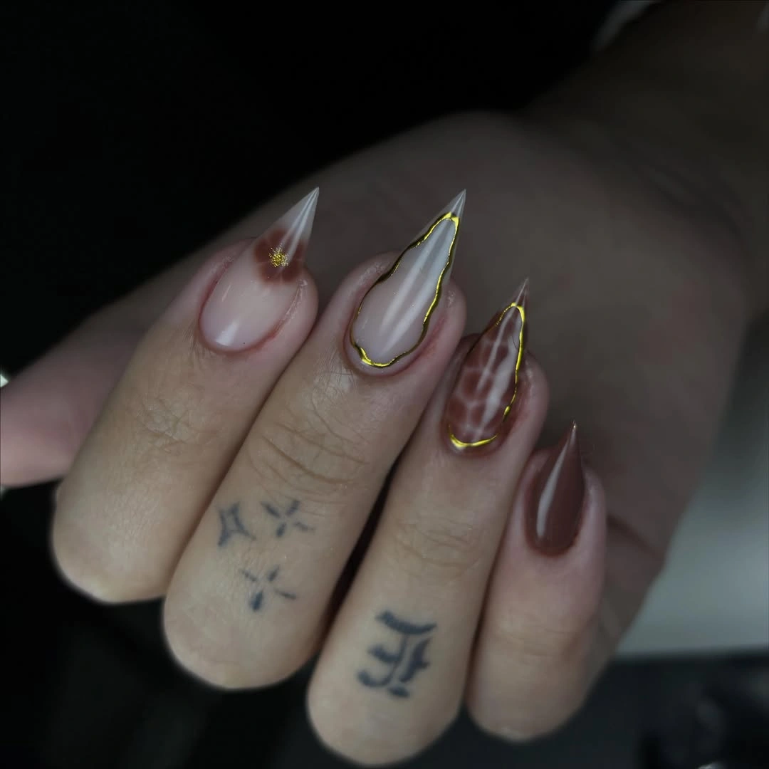 Long almond nails with thin brown outlined tips