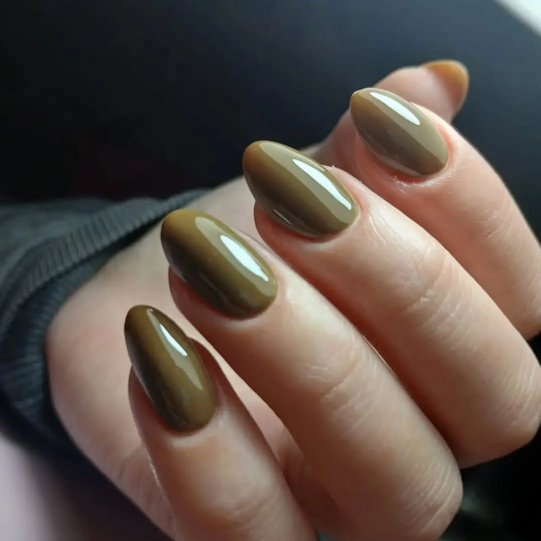 Short oval nails in glossy olive brown polish