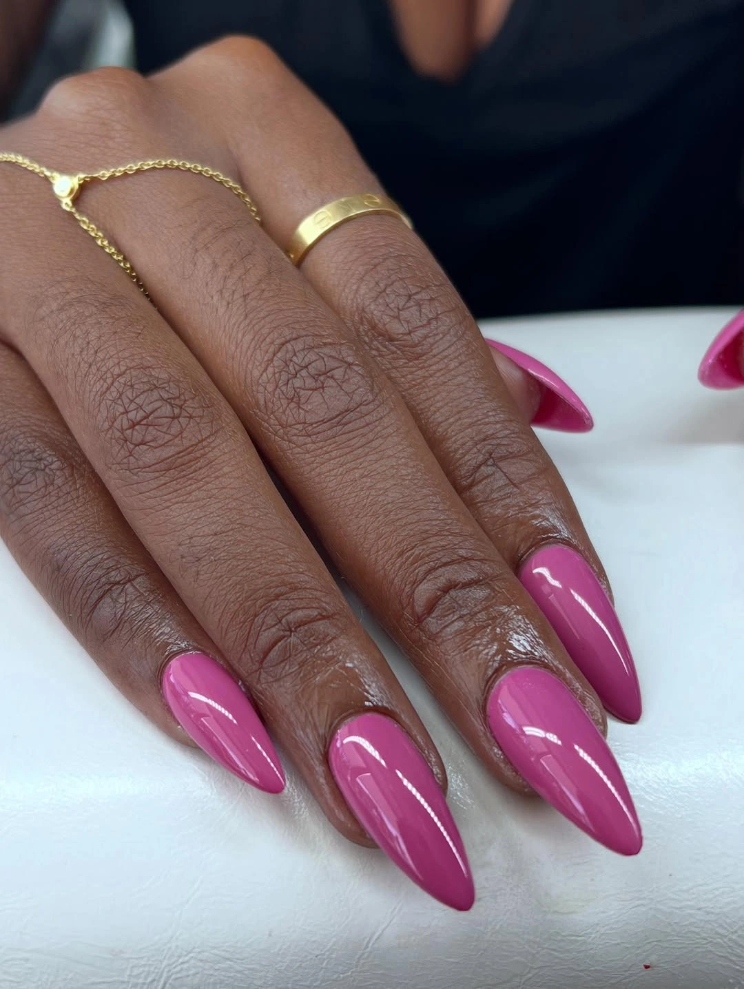 Long pointed nails in bright glossy fuchsia pink