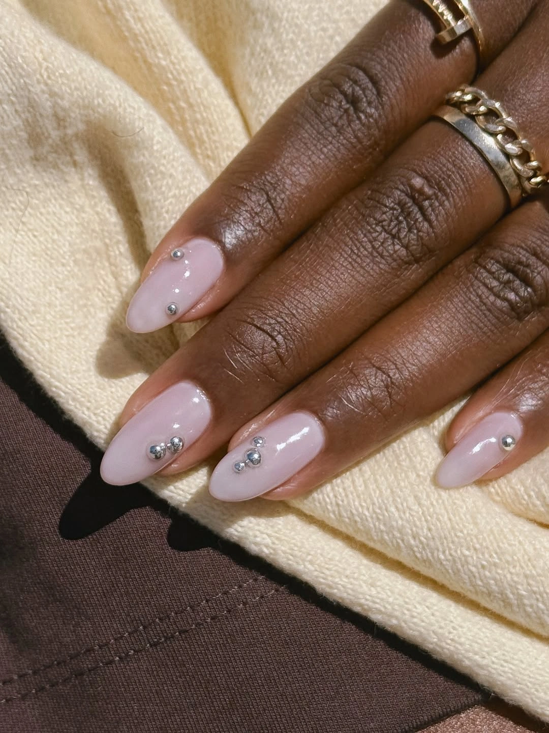 Pale lavender almond nails with small silver stud accents