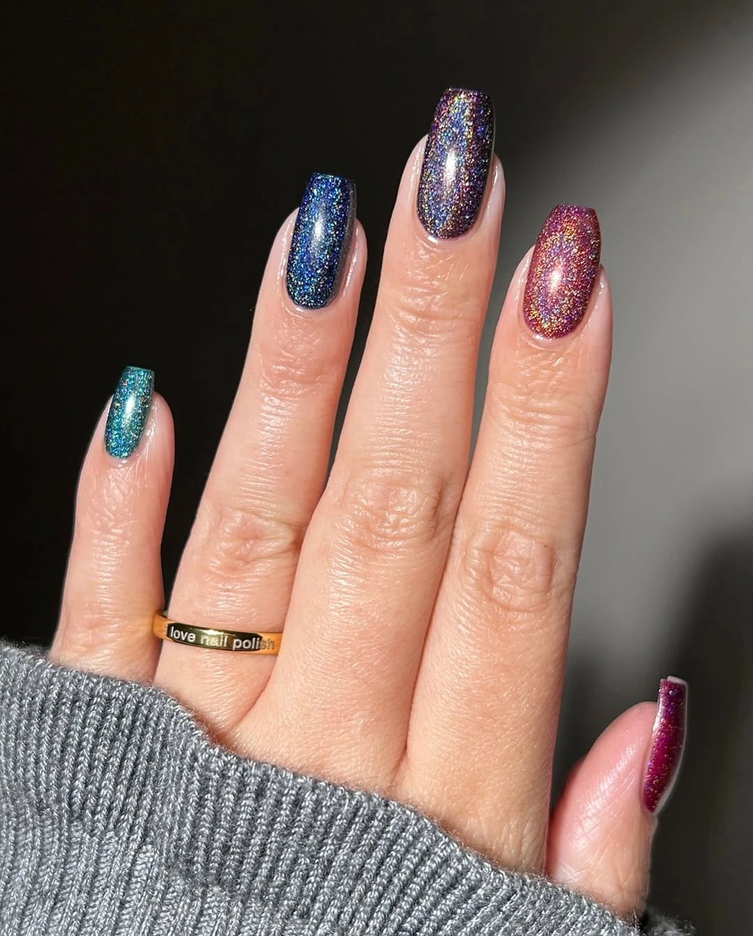 Long nails with blue teal and magenta glitter finishes