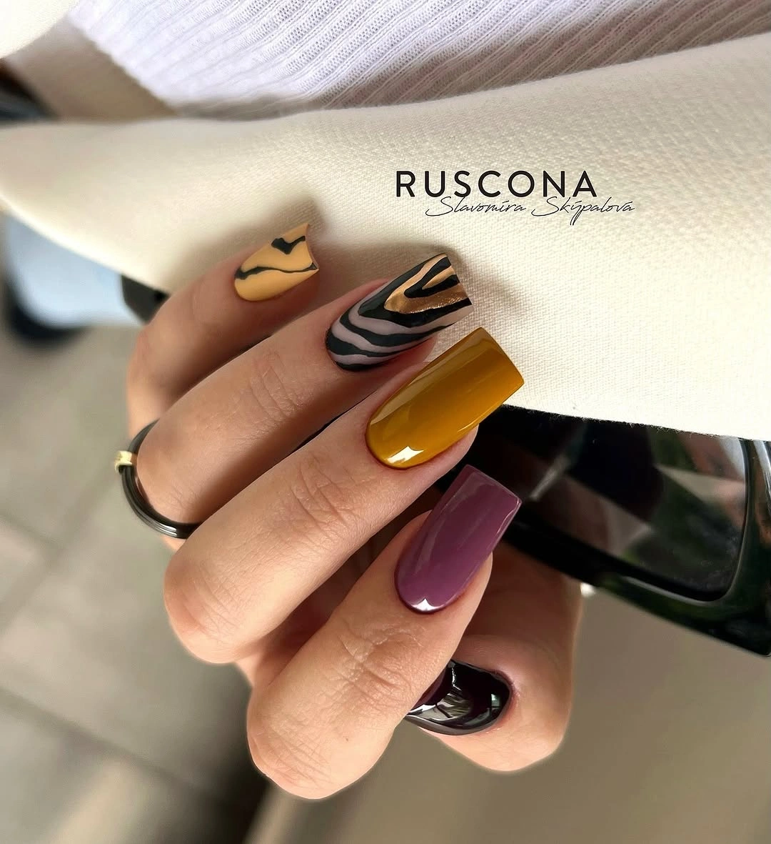 Mustard cream mauve and black abstract swirl nails