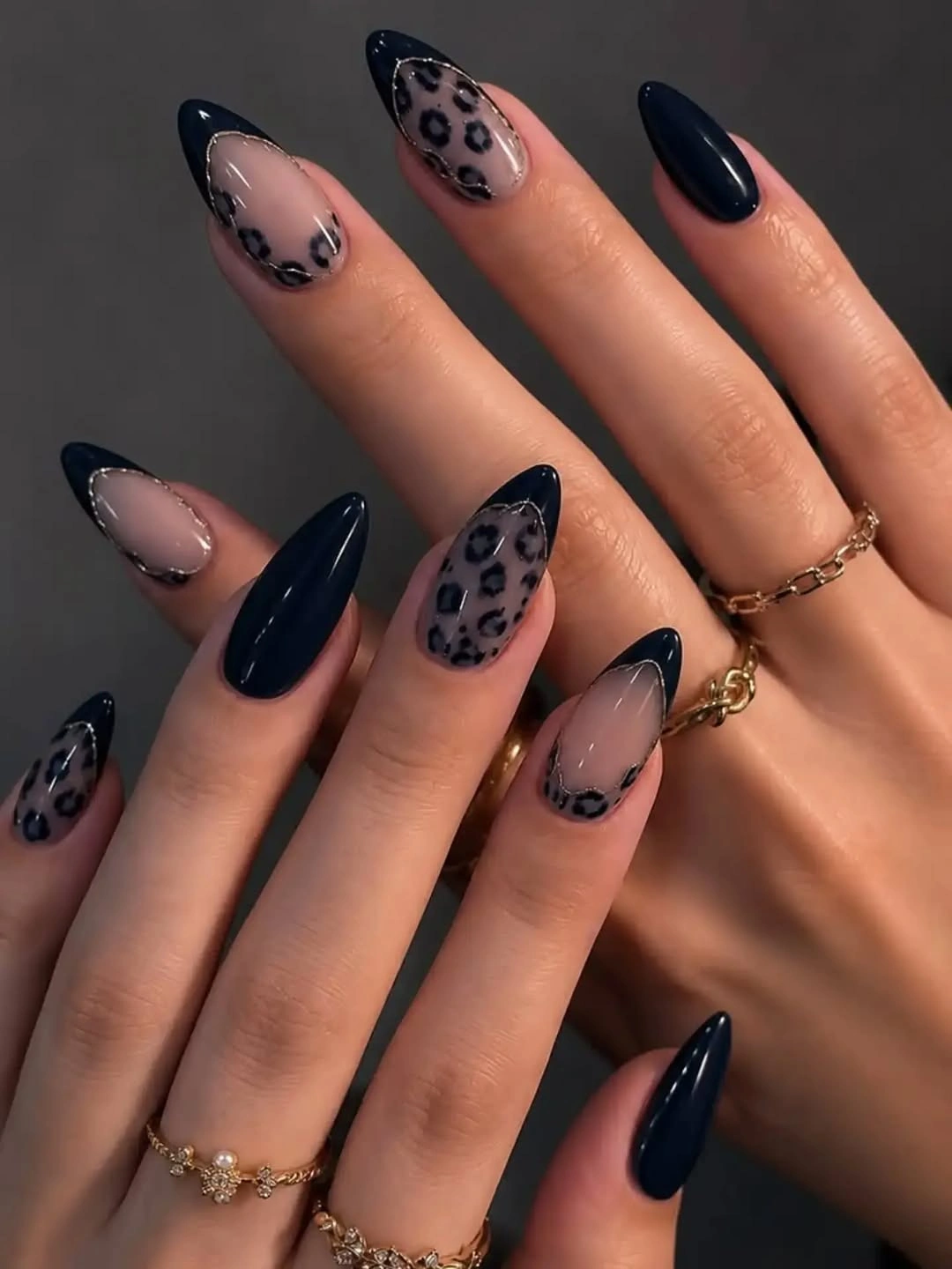 Navy stiletto nails with sheer nude leopard print accents