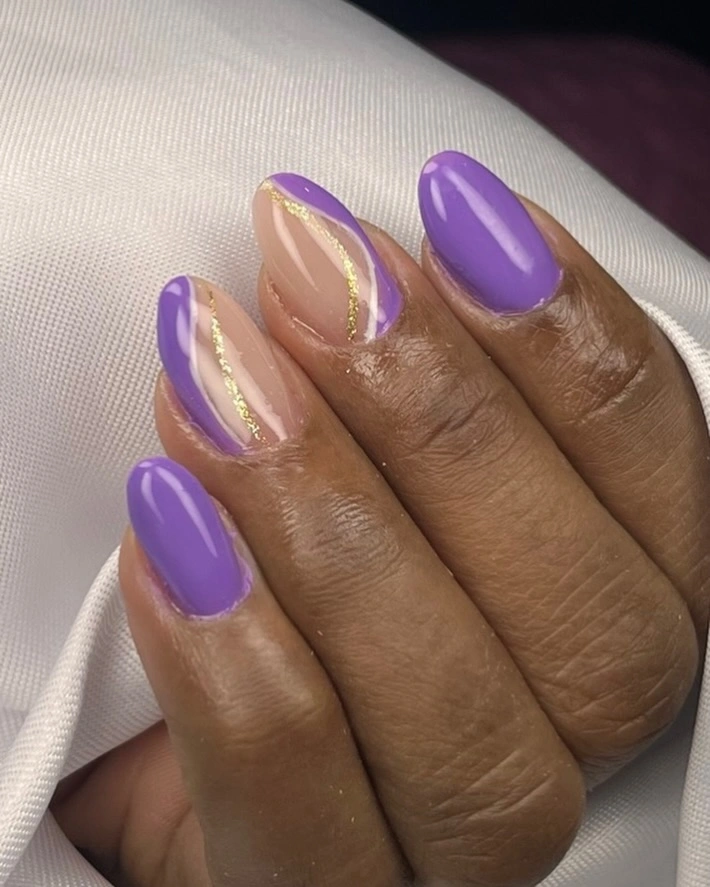 short purple nails with delicate gold accents