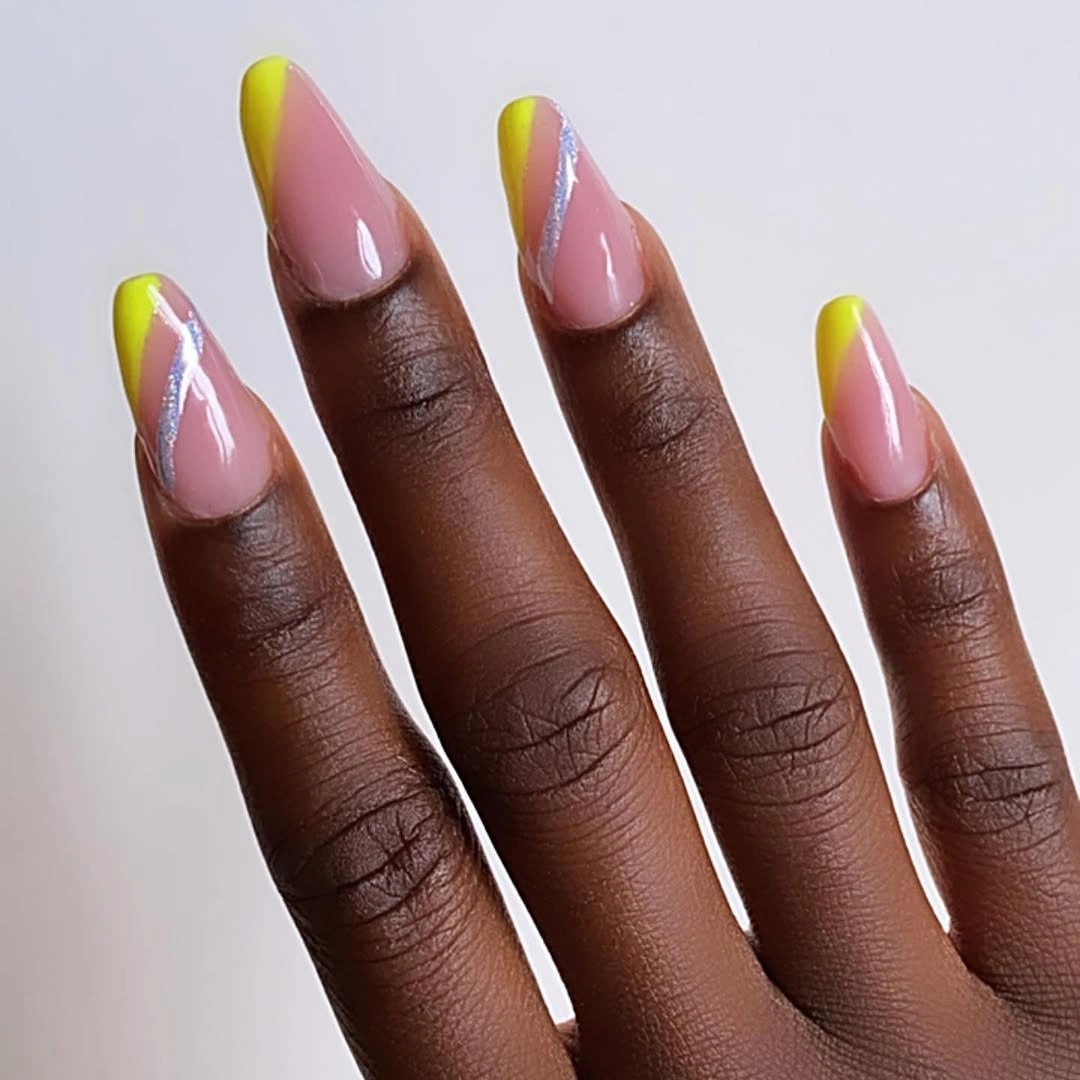 long almond blush nails with neon yellow green tips