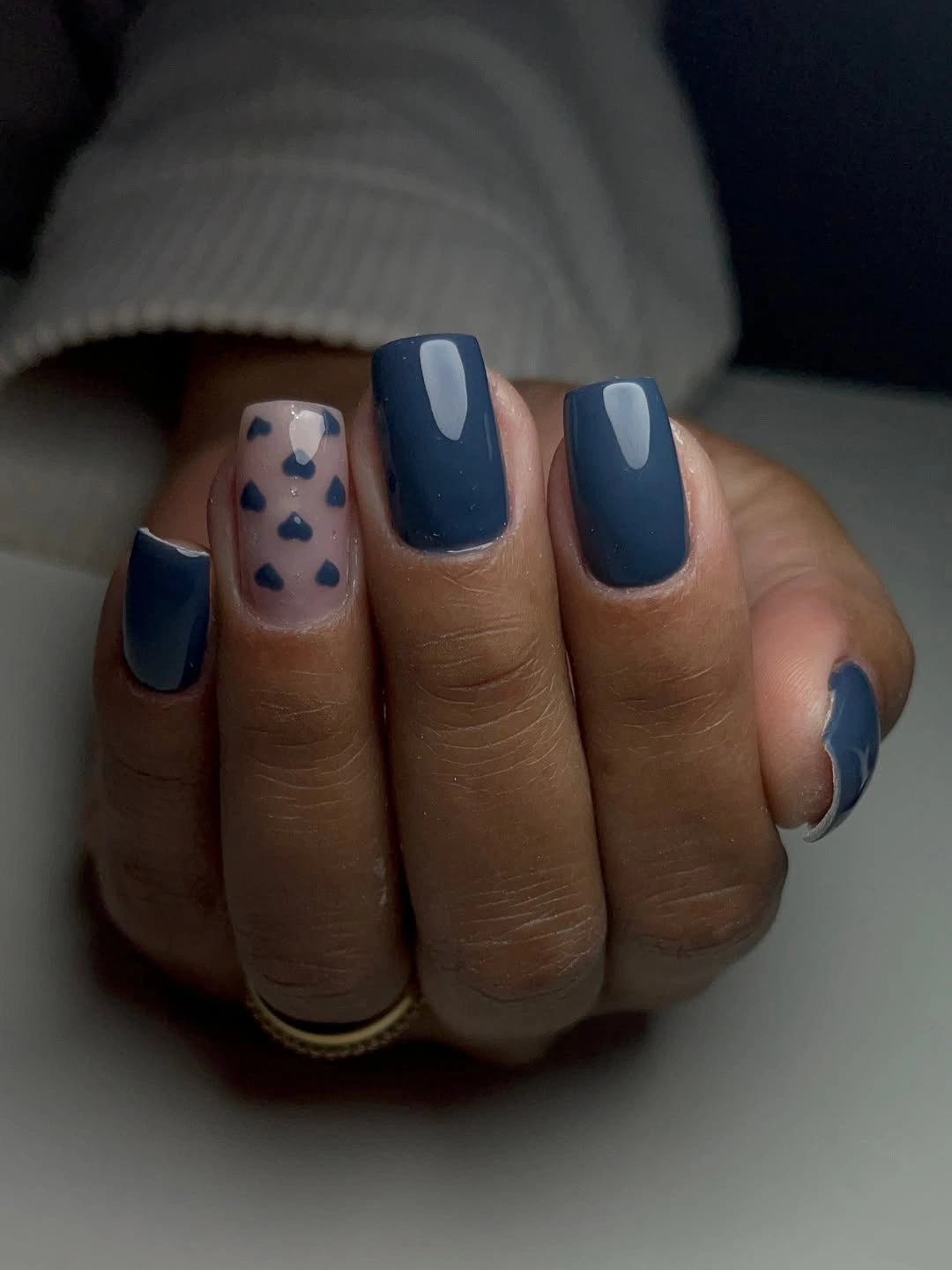glossy navy nails with one tiny patterned accent