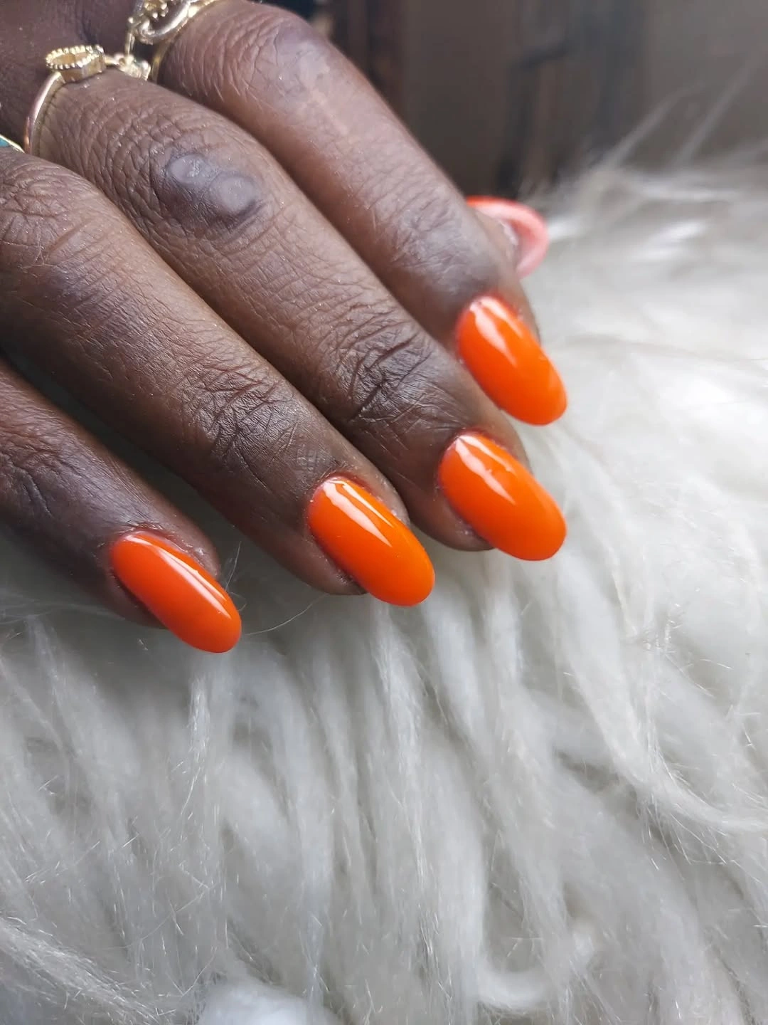short rounded nails in vivid glossy orange