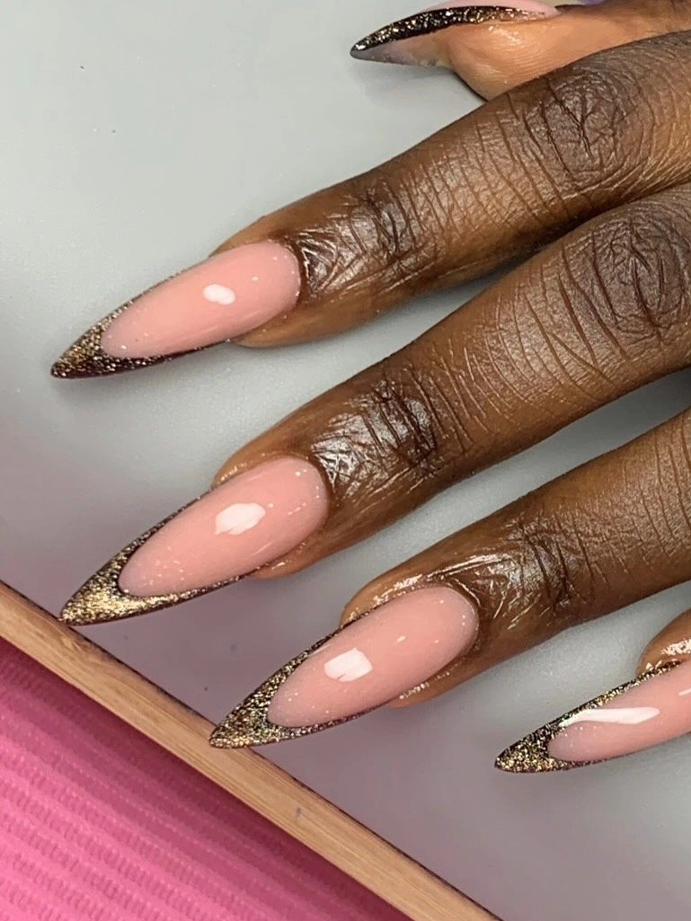 long almond pink nails with fine gold edging