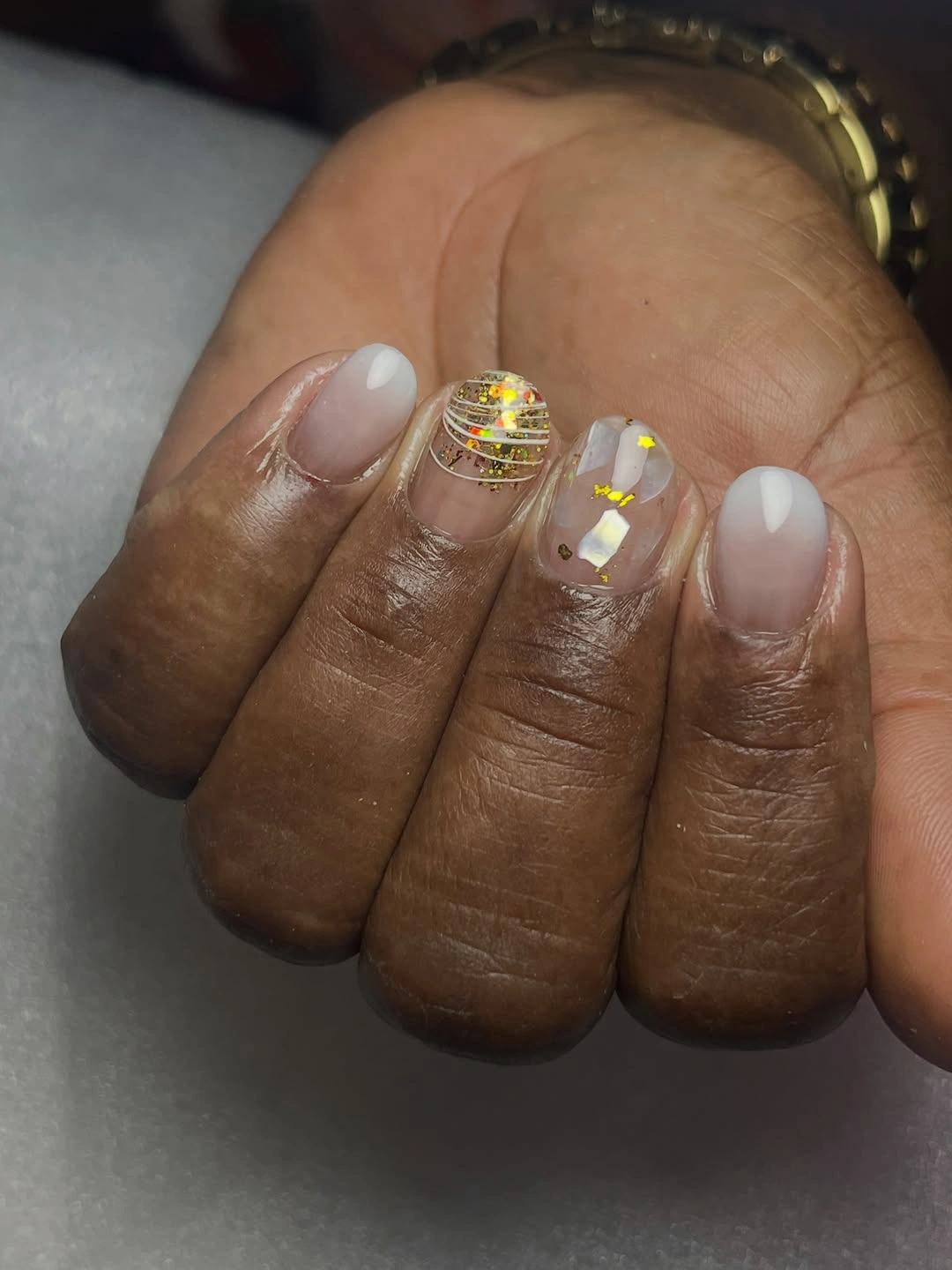 short sheer nude nails with tiny gold accents