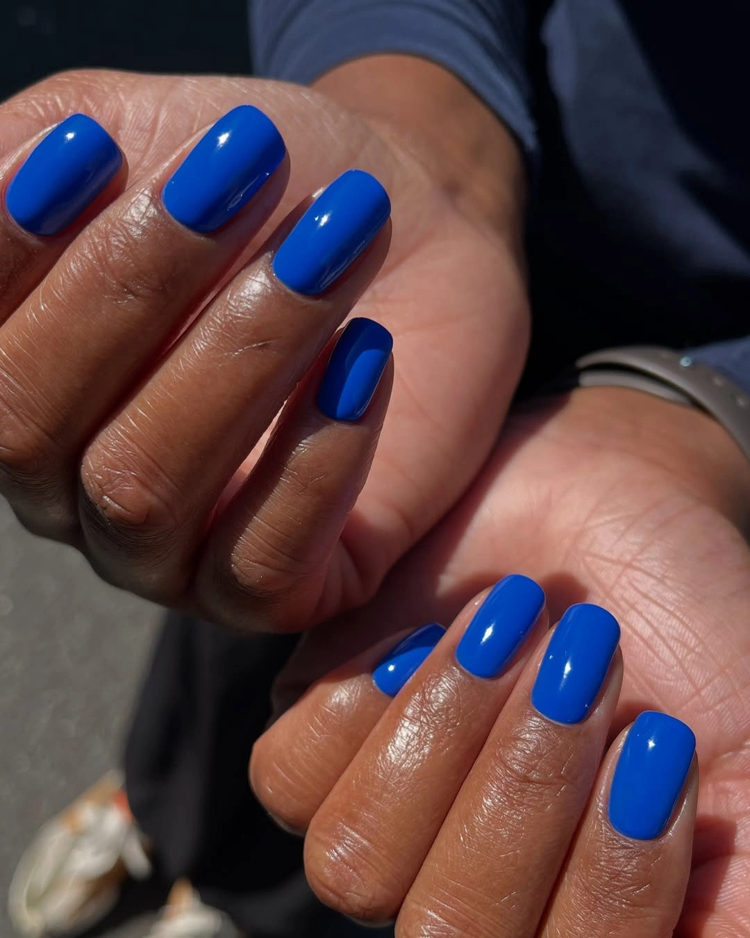 Short oval nails in a saturated glossy cobalt blue shade