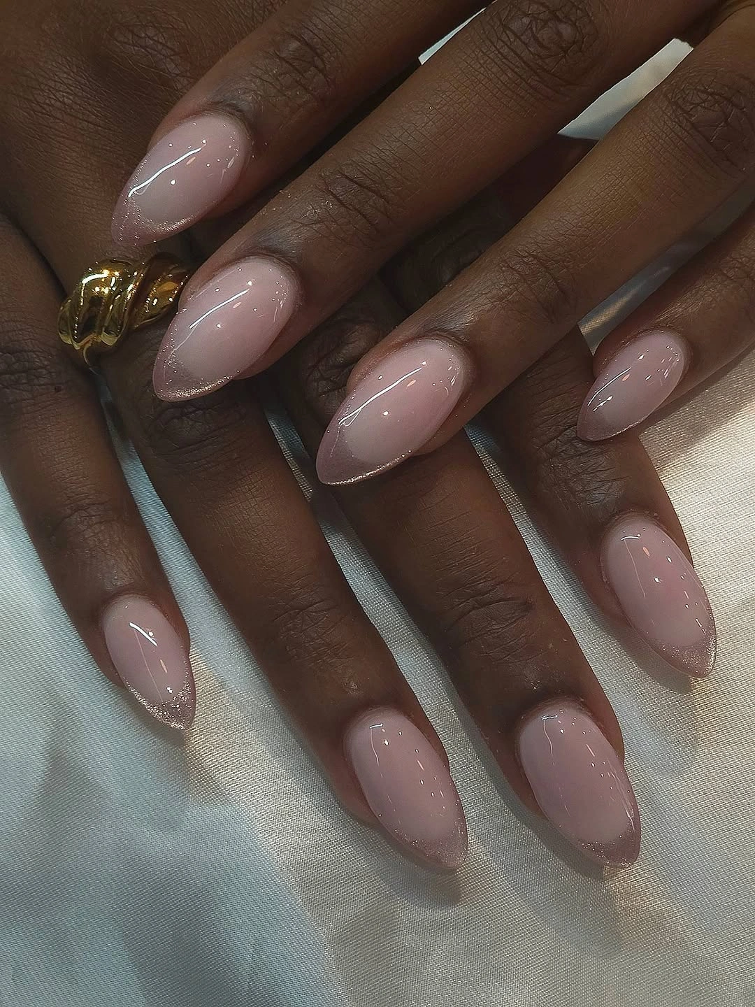Long almond sheer pink nails with silver borders and raised swirl details