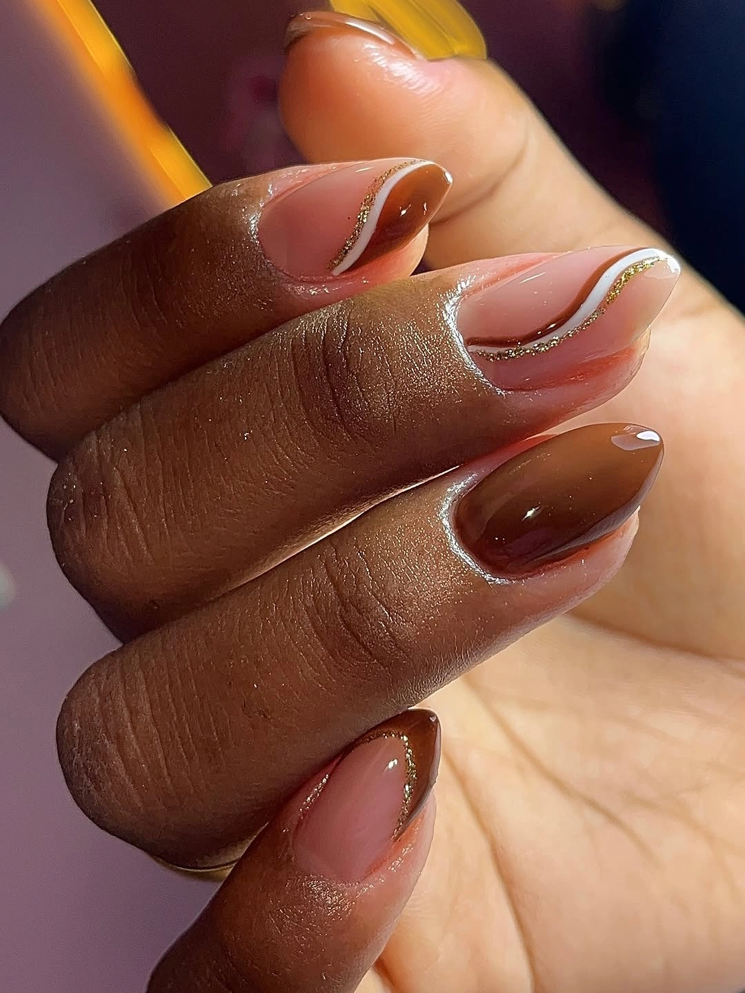 Long almond sheer nude nails with red white curved tips and gold flecks
