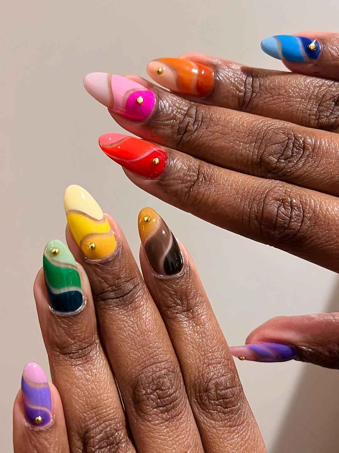 Short almond nails with bright multicolor tips and glossy abstract blocks