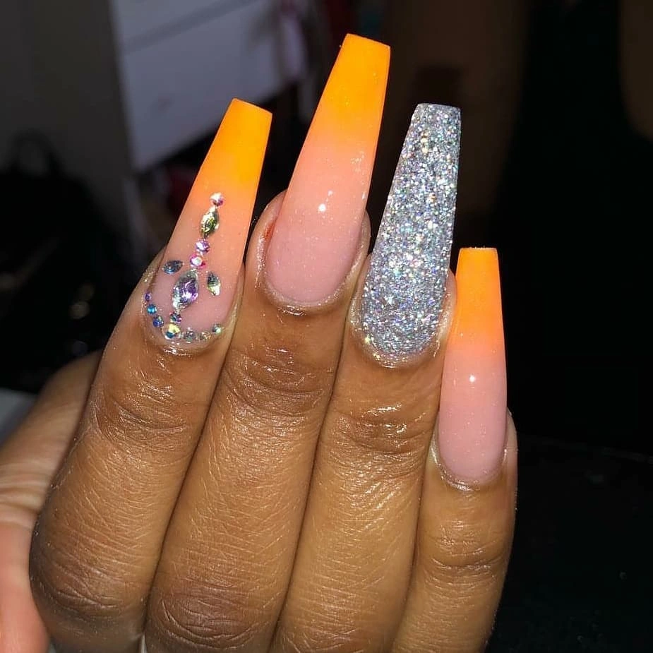 Long coffin neon orange pink and silver glitter nails with stone accents