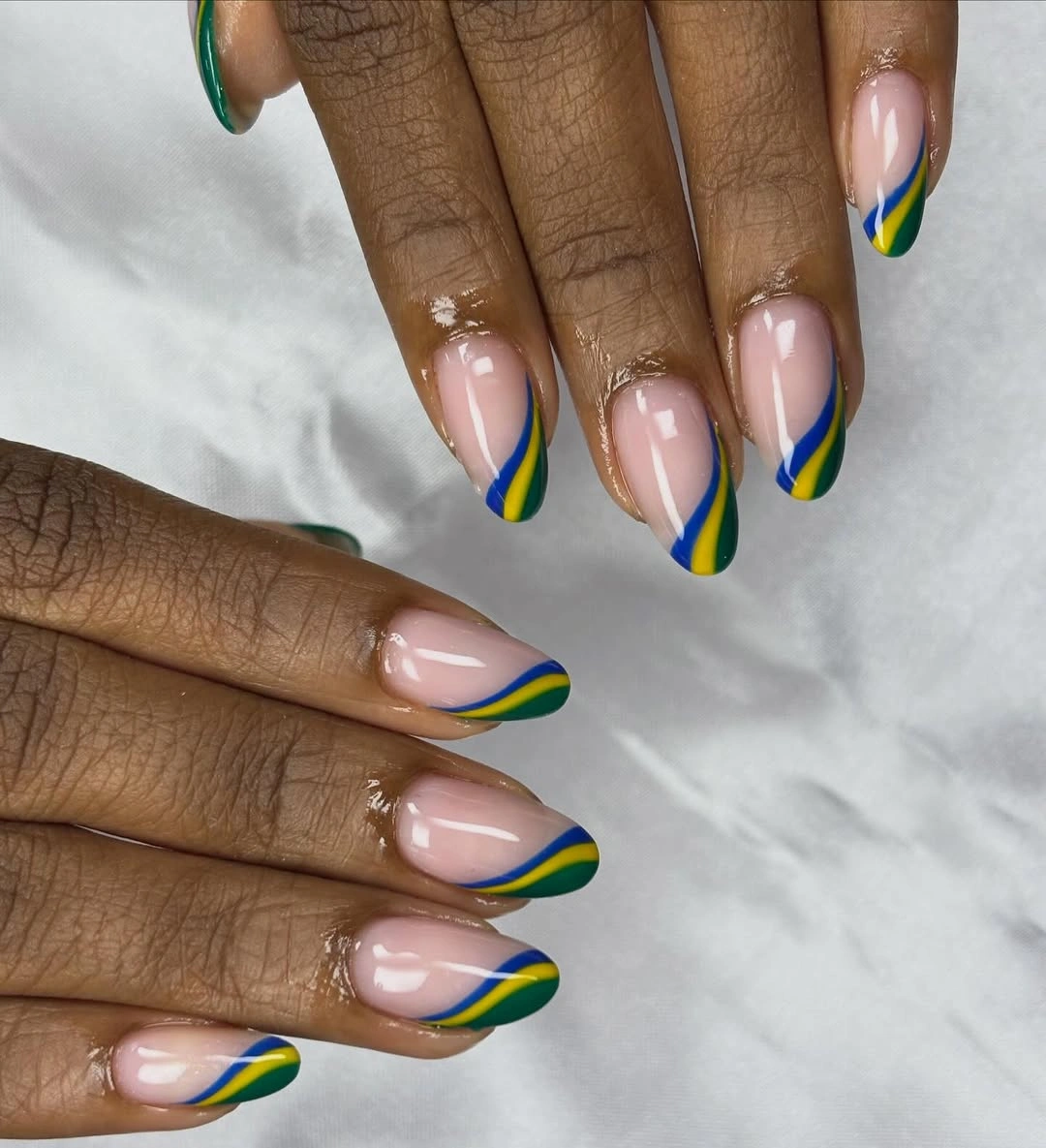 Short square pink nails with green yellow and blue curved French tips