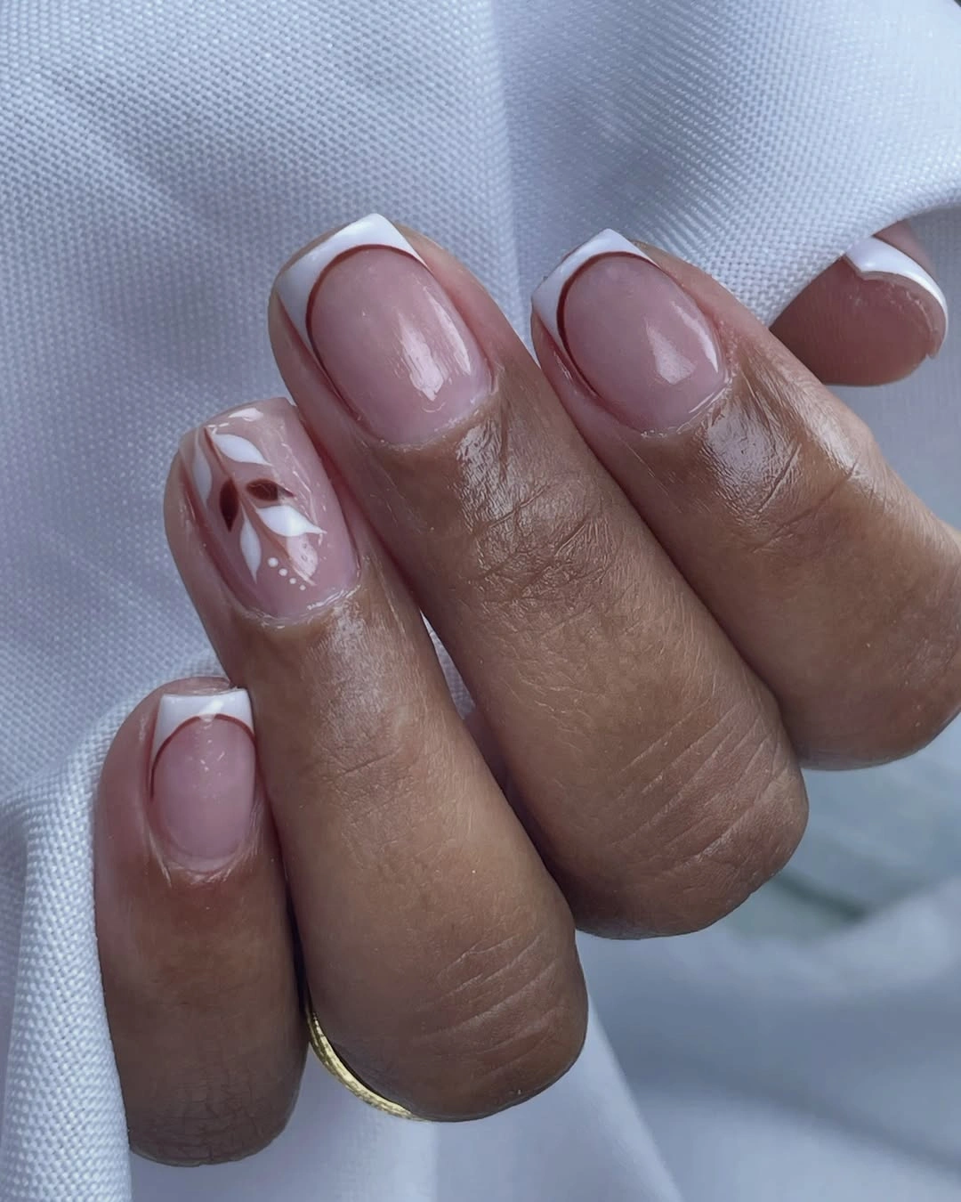 Short square blush nails with white abstract accents and slim gold edges