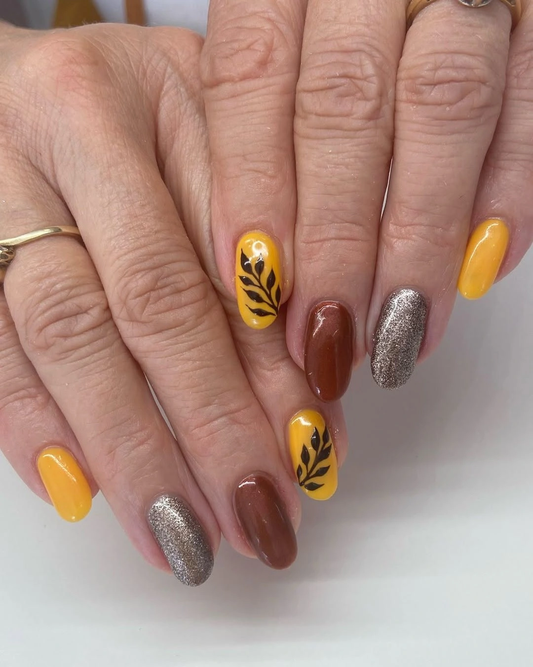 Short square mustard cocoa silver and black leaf nails