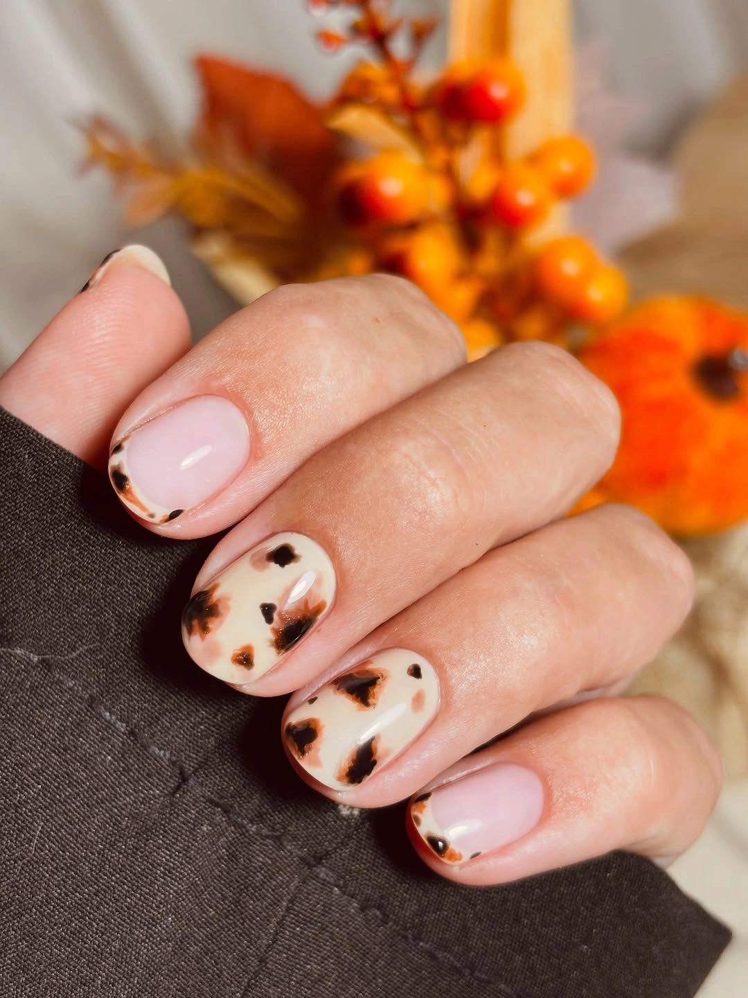 Short pale pink nails with soft brown tortoise spots