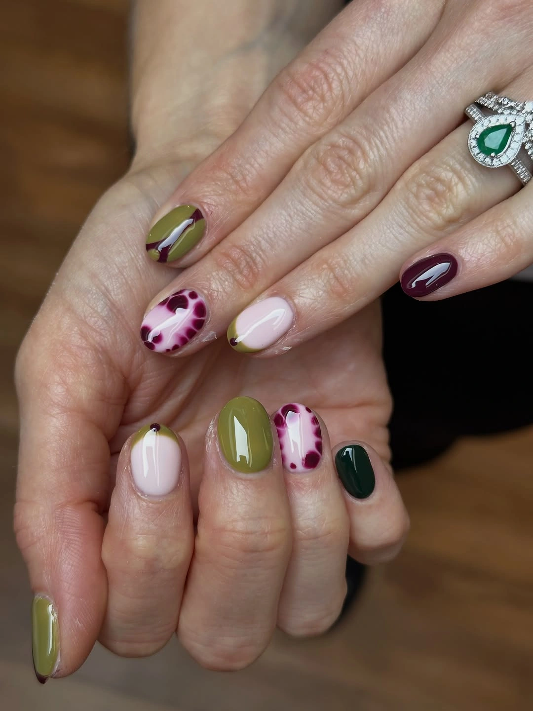 Short olive pink and berry nails with small mixed prints