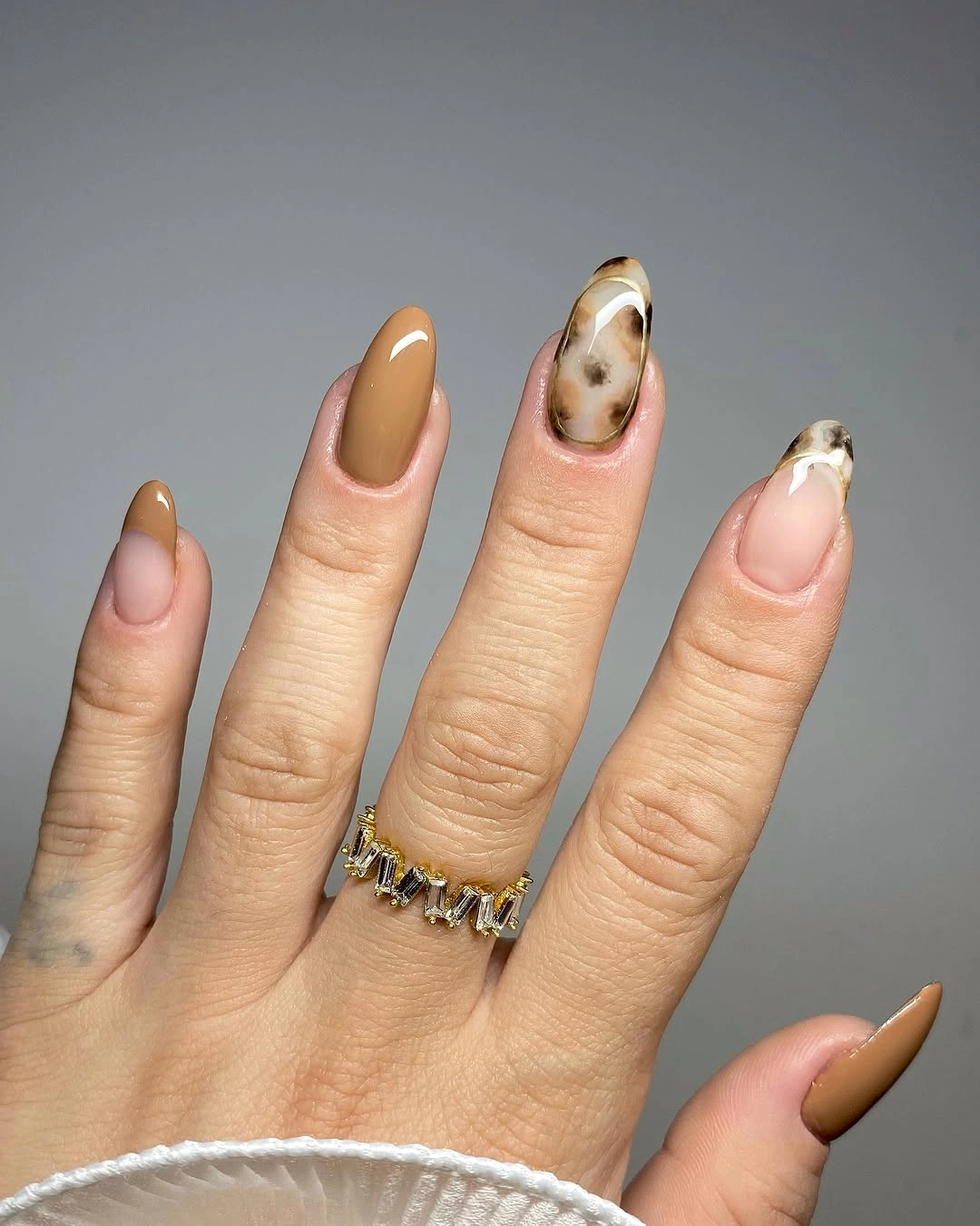 Caramel almond nails with creamy brown marbled swirl accents