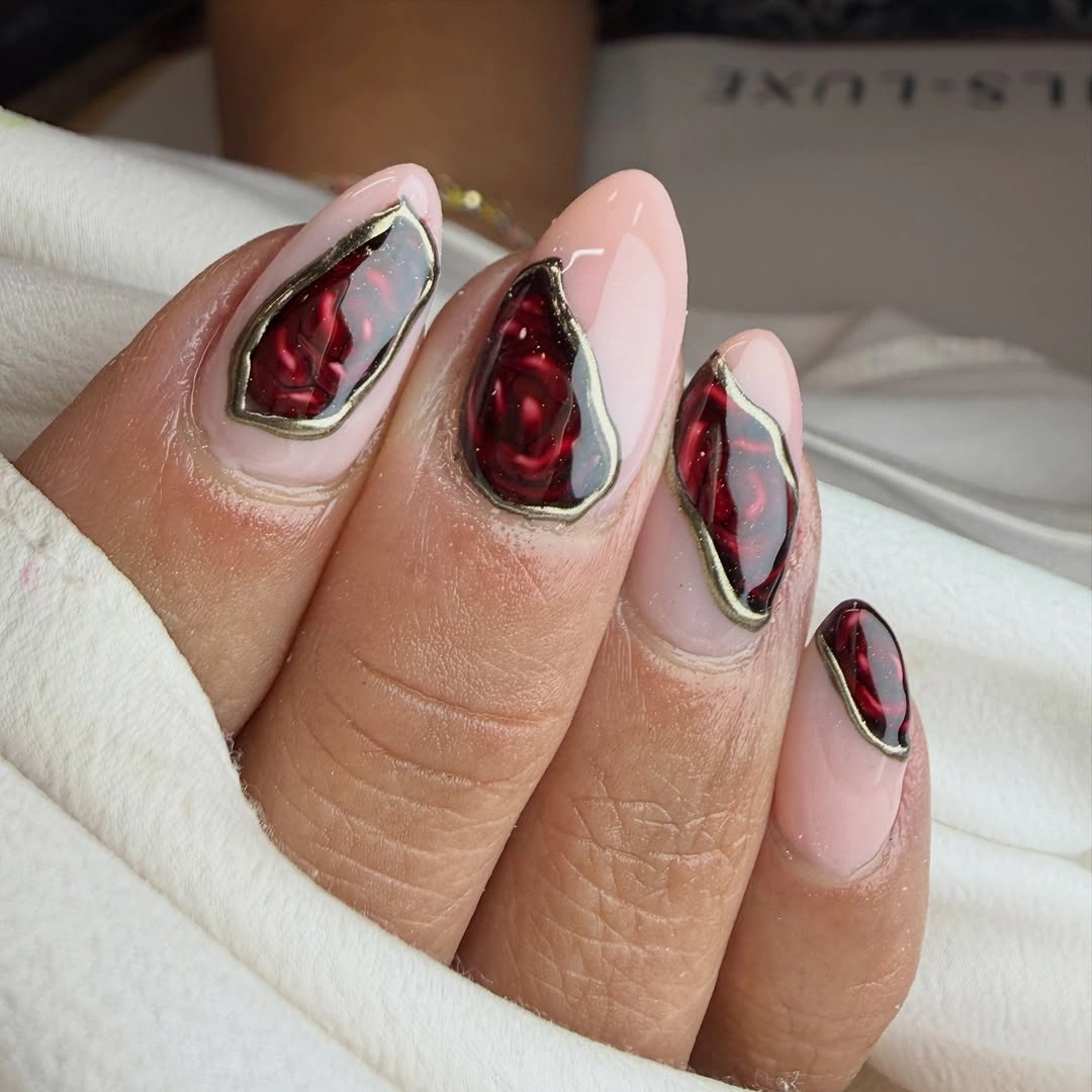 Blush almond nails with dark burgundy faceted framed panels